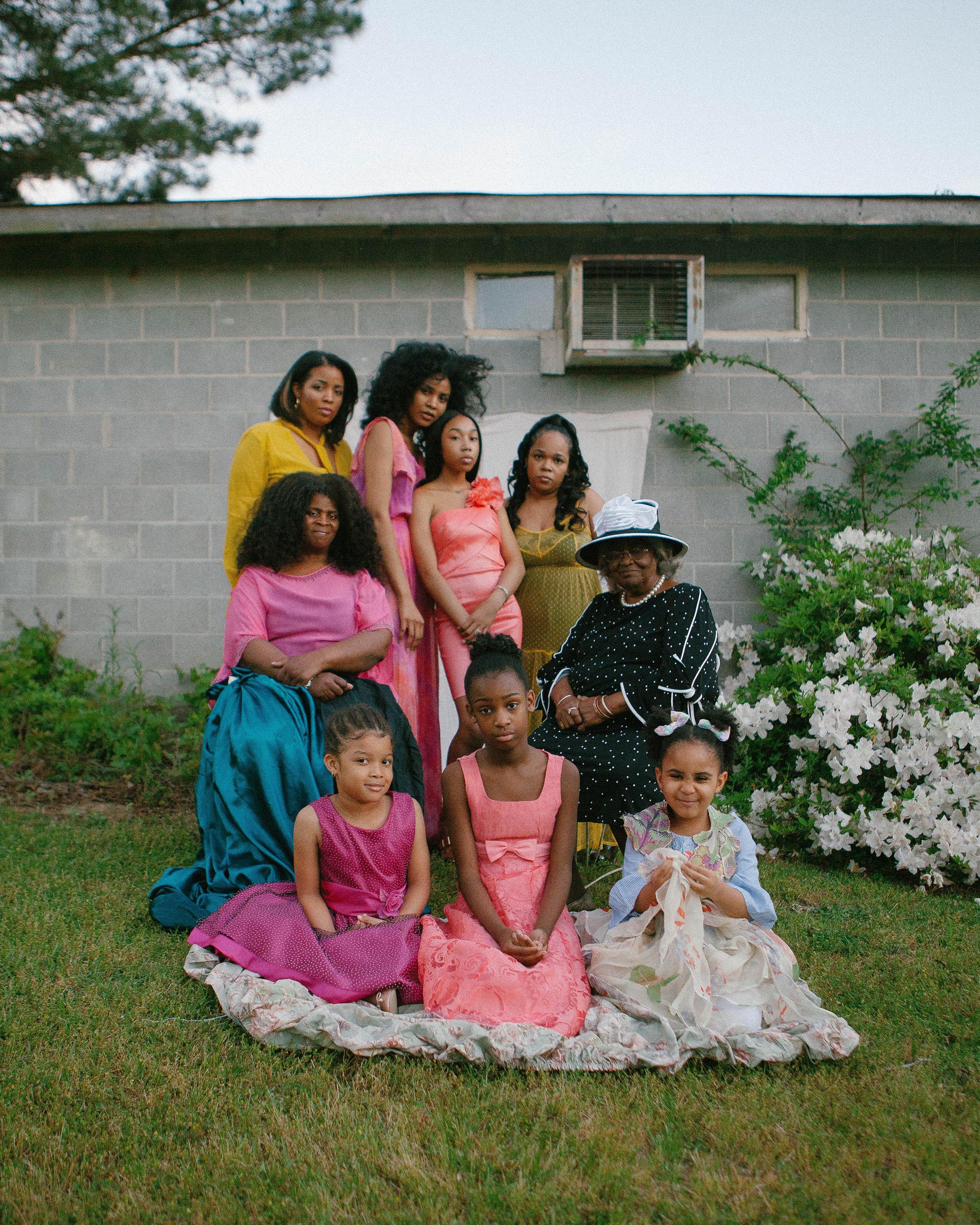 Jazsalyn’s Family, Kennedi Carter, 2019.Textile designer, Jazsalyn McNeil, stands with three generations of family on her grandmother’s farmland. (Left to right) Unissha, 35; Jazsalyn, 27; Niyla, 15; Wyshana, 40; Cheryl, 60; Gertrude, 83; Uraya, 6; Samarah, 12; Arabella, 4