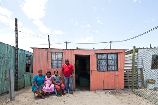 Phumezo's family home before building he volunteered to replace his house with the Empower Shack prototype