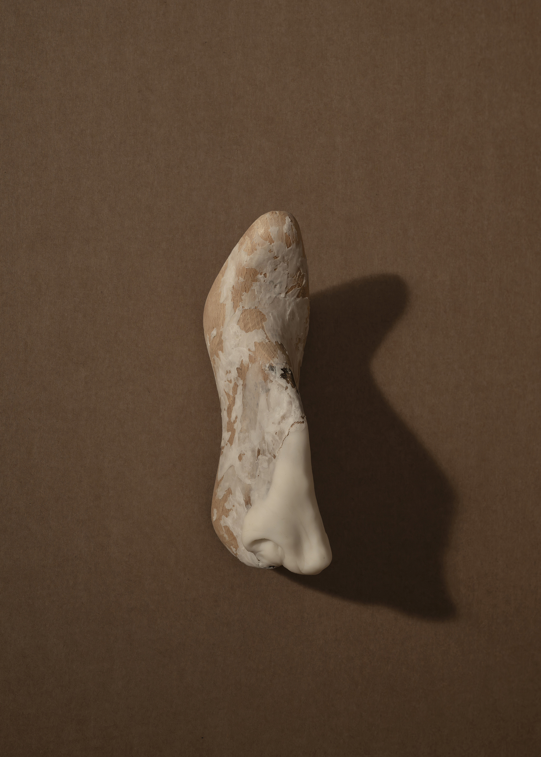 Sprain (38), 2023. Antique wooden last and air-dry porcelain. 24 x 11,5 x 8 cm
