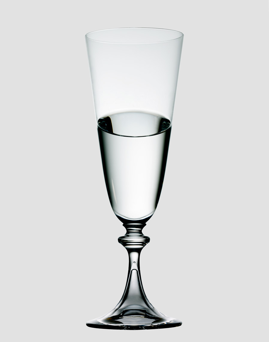 KMA stylist Sara Wacksman designs set for a photo of a clear wine glass with water in it with a grey background