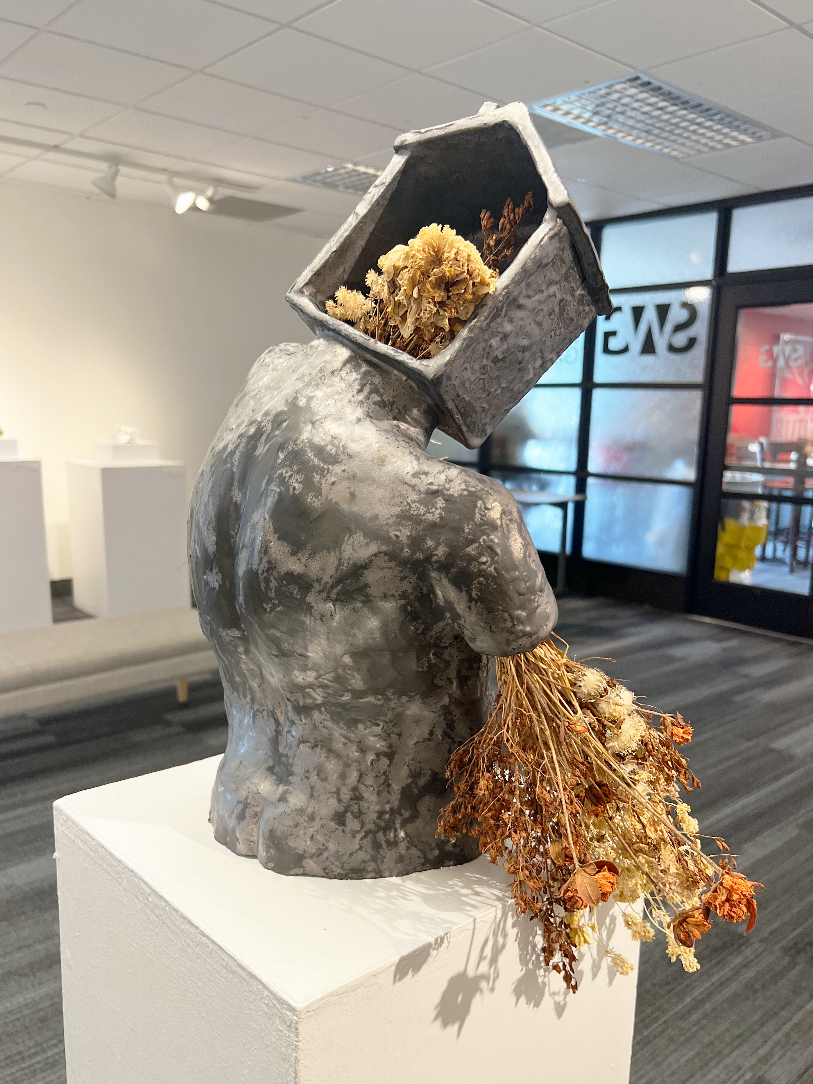 Innocence. 2022. 13 x 18 x 8 inches. Earthenware, glaze, dried plants.  