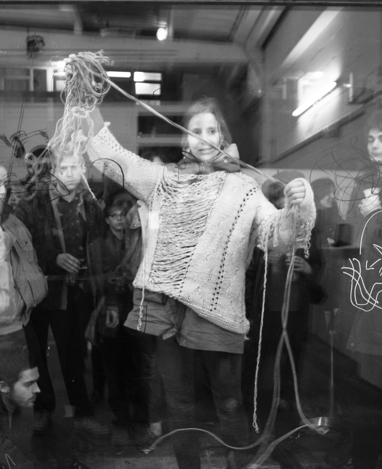 Artist: Franziska Windolf. Partially unravelled sweater and elastic ropes. Drawings of knots by the audience on a glass plane. 2018. Image: Amber Hahn.