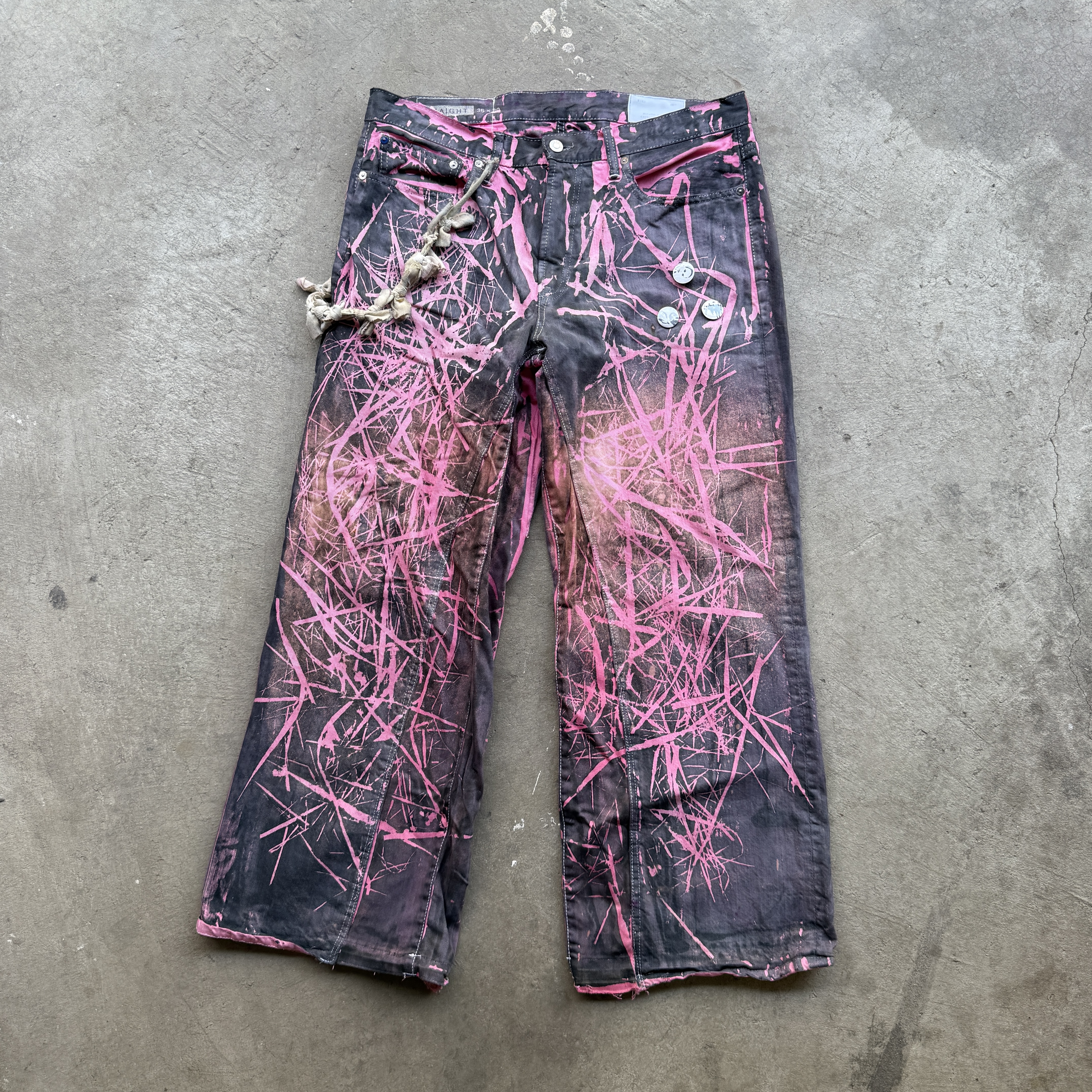 Reclaimed vintage surplus denim screen printed with grass pigment & textile dye. Tailored to give straight/wide fit. Fitted with dyed scrap chain, leather back patch, and custom buttons.