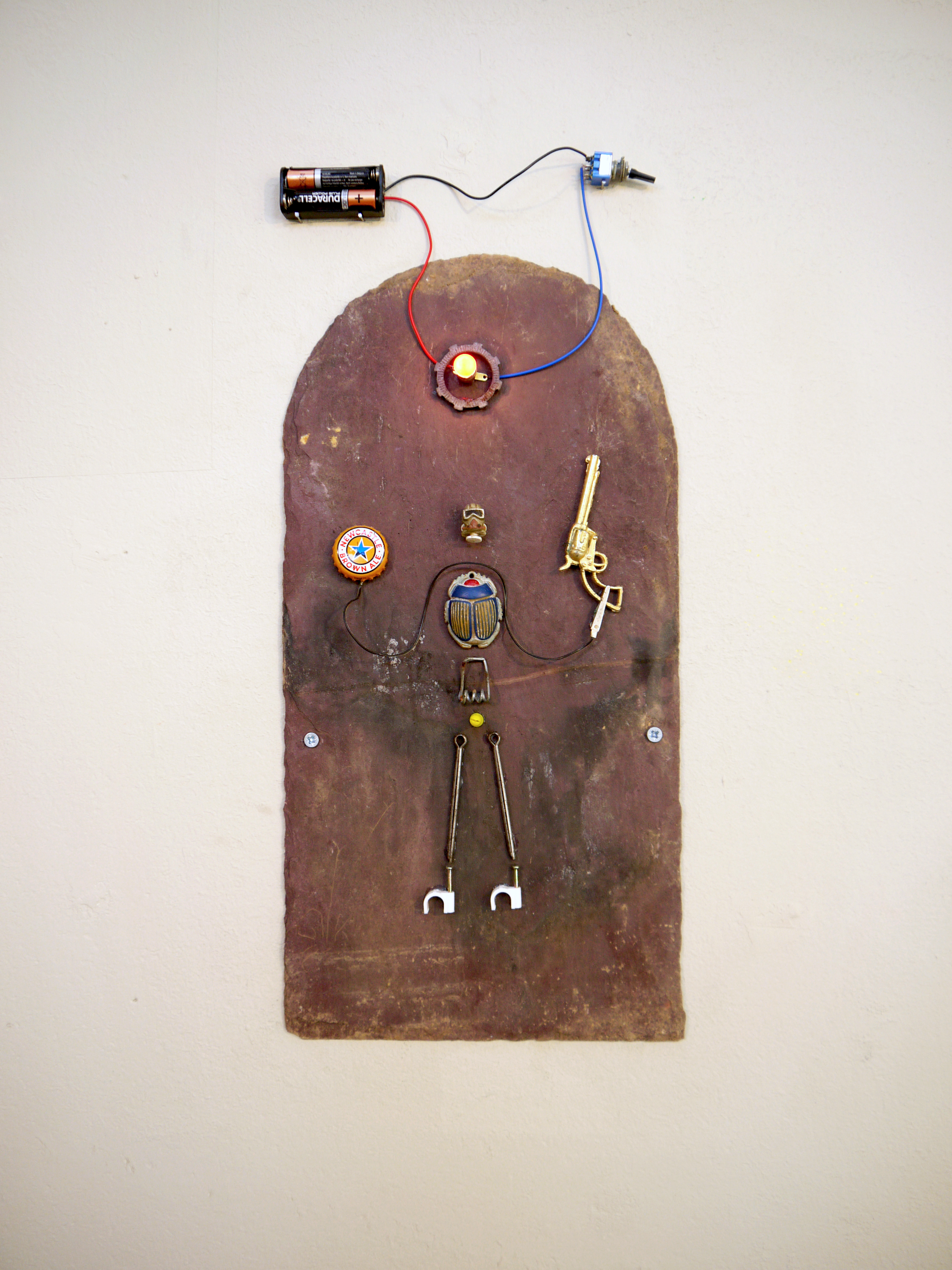 SpaceMan, 2018. Slate, found object, bulb circuit. Milo Kester