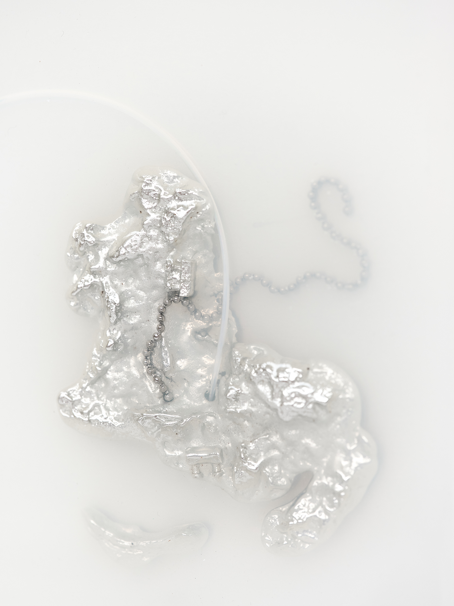 Imperma_38°00’04”N 100°54’43”E, 2024,  [60cm x 50cm x 20cm]  Eco resin, aluminium, pewter, labels, found metal components and drain chain 