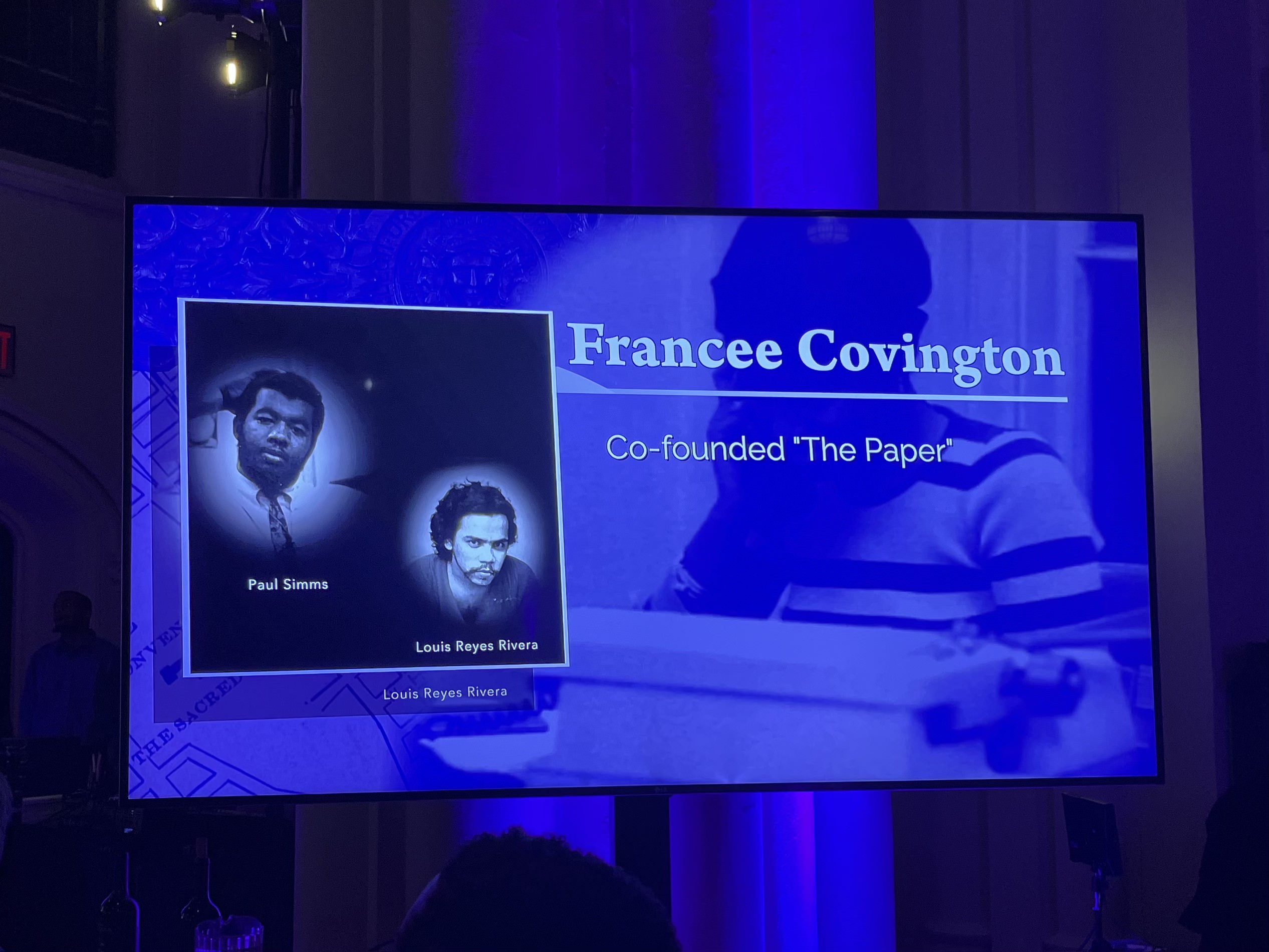 Pictured: Televison screens were set up throughout the Great Hall to project the Townsend Harris Medalists' award videos. The pictured scene from the video acknowledges Francee Covington, Louis Rivera, and Paul Simms for co-founding The Paper.