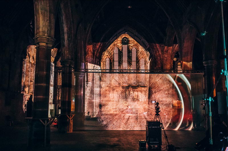 Abstract visual projection mapping across the gothic arches of Carlisle Memorial Church during Max Cooper’s Red Bull Music performance.