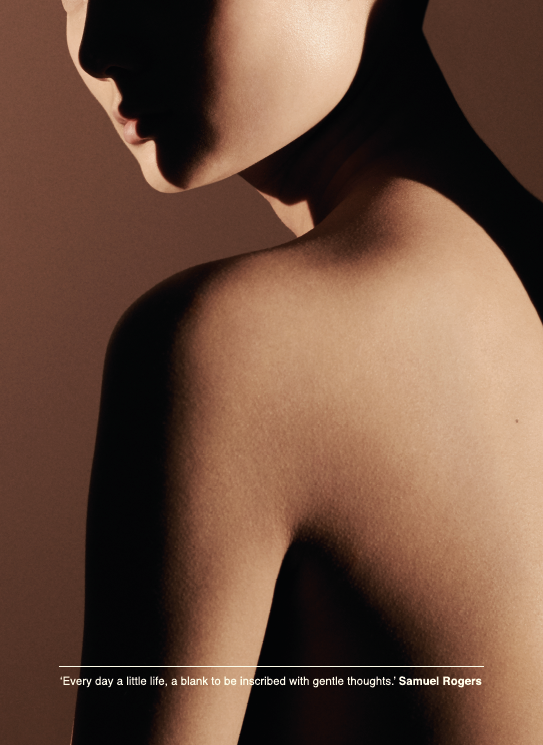 A tightly cropped profile of a person’s face, neck, and shoulder. Light falls softly across their skin.