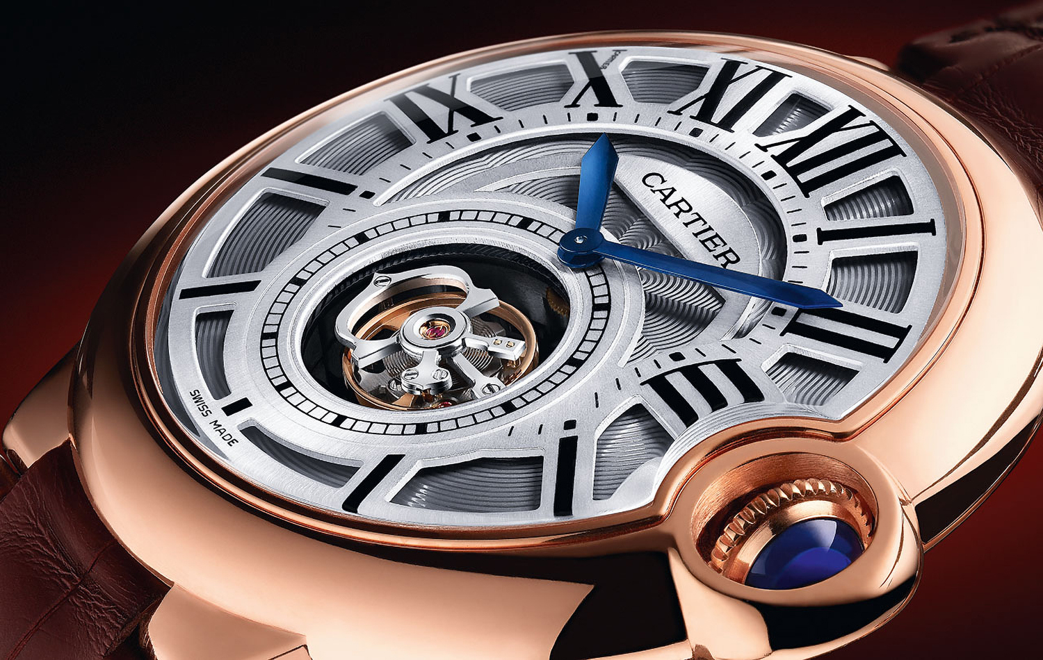 KMA photographer Daniel Schweizer photographs a close up of a gold and silver Cartier watch with blue clock hands