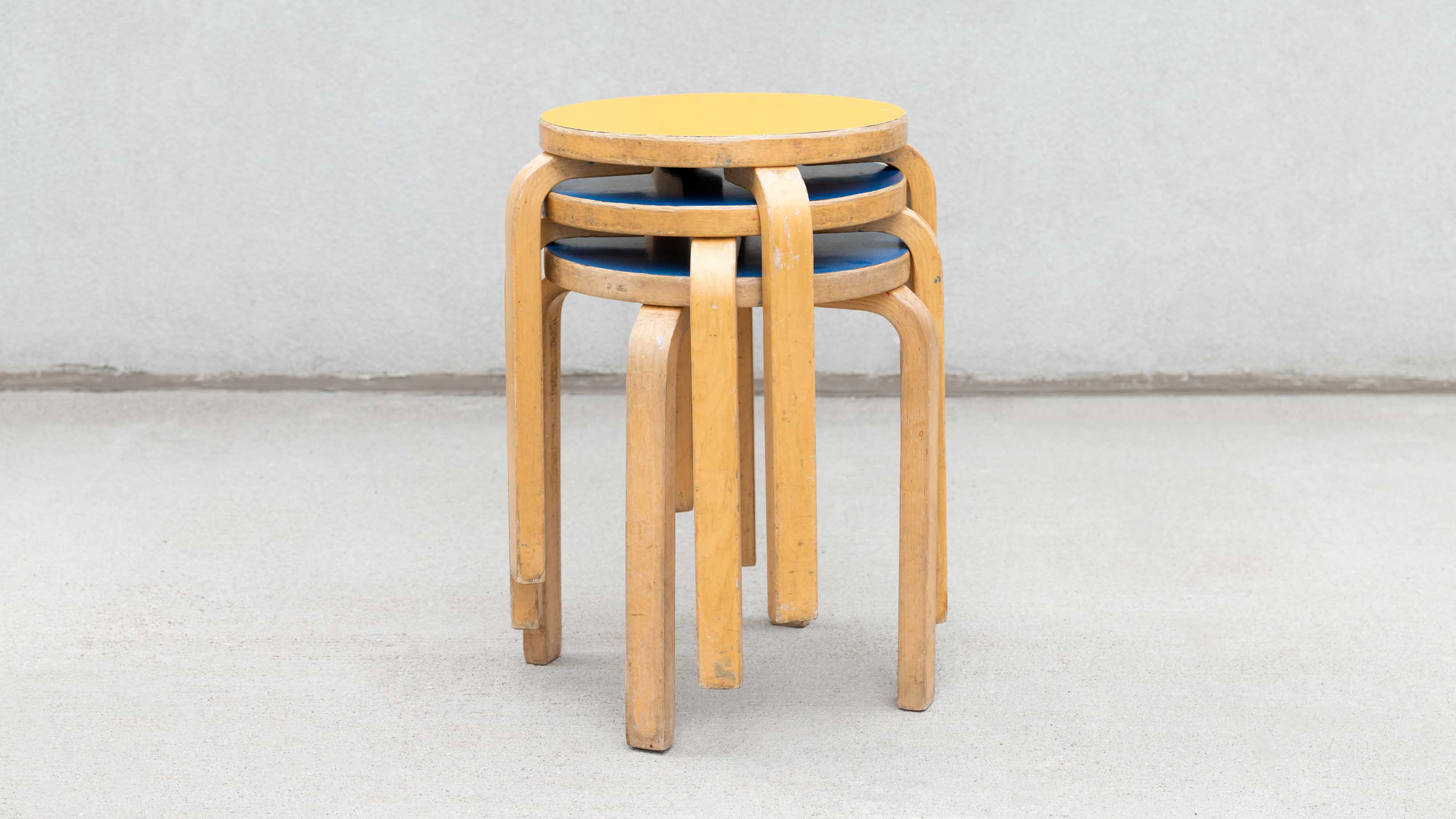 early blue linoleum and yellow linoleum Alvar Aalto stools 1970s sweeterfat collectible furniture for prop rentals nyc mcm furniture