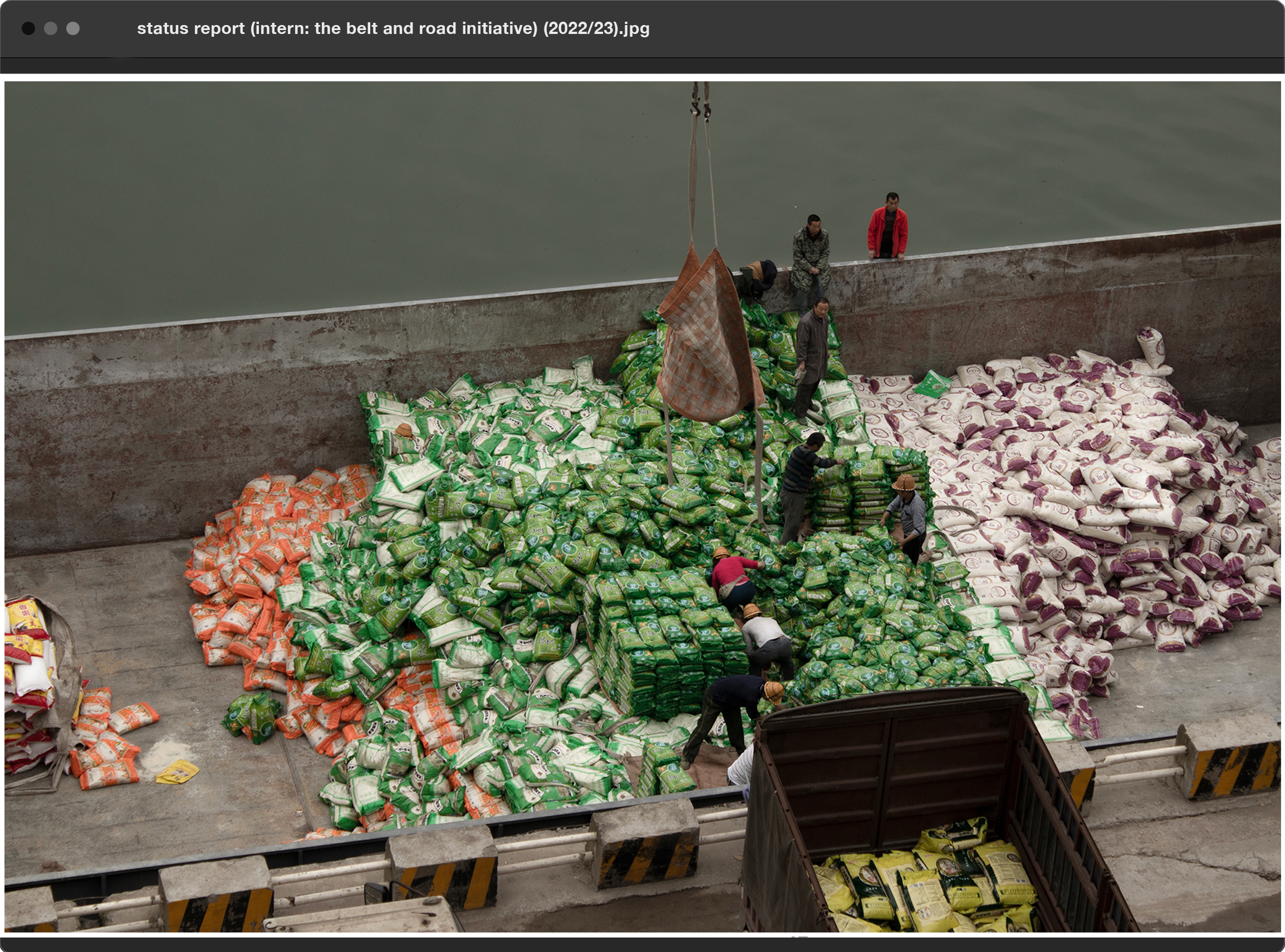 workers on a ship transporting bags of rice in china 