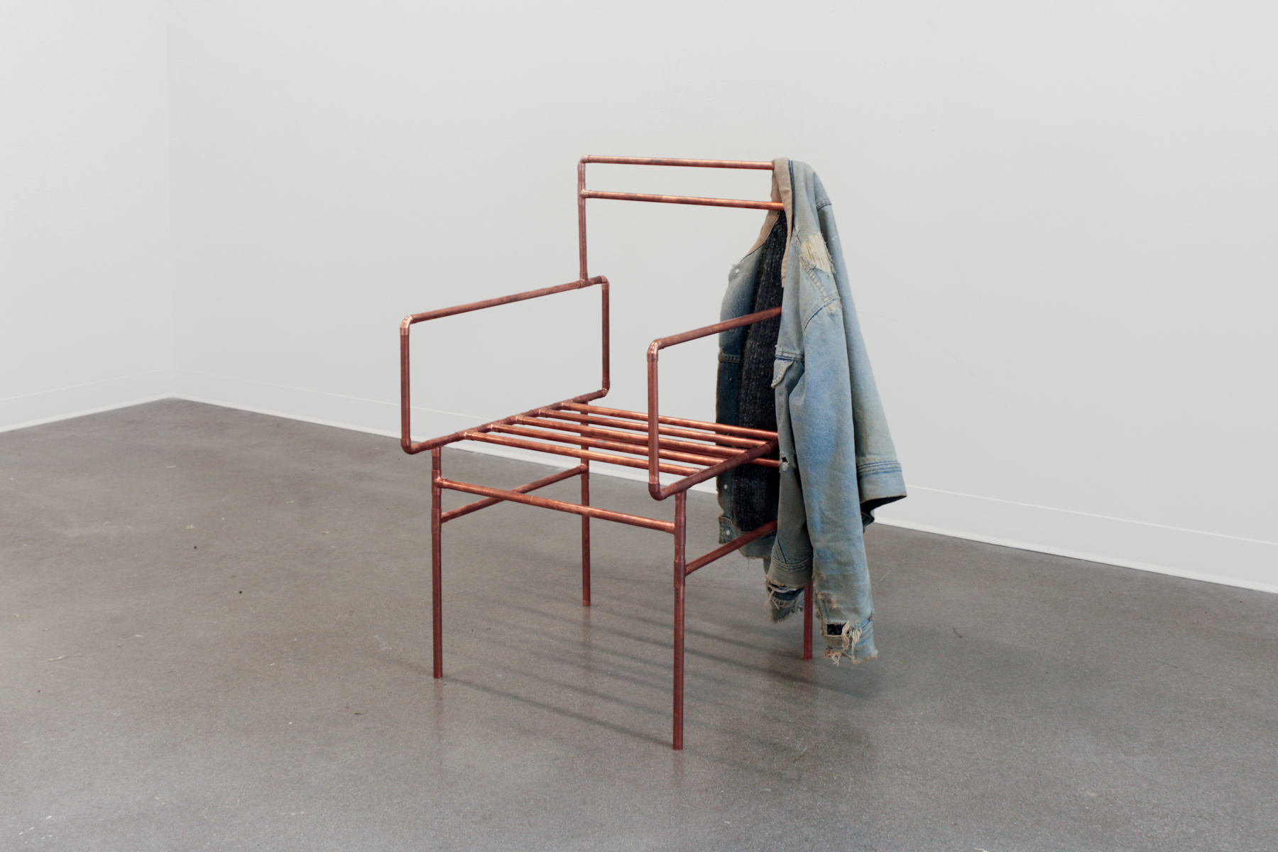 Untitled, 2016–2017, jacket sourced from an RMG factory in Gazipur that has experienced mass hallucinations and ghost attacks; copper piping, 34 x 24 x 24 in. (86 x 61 x 61 cm)