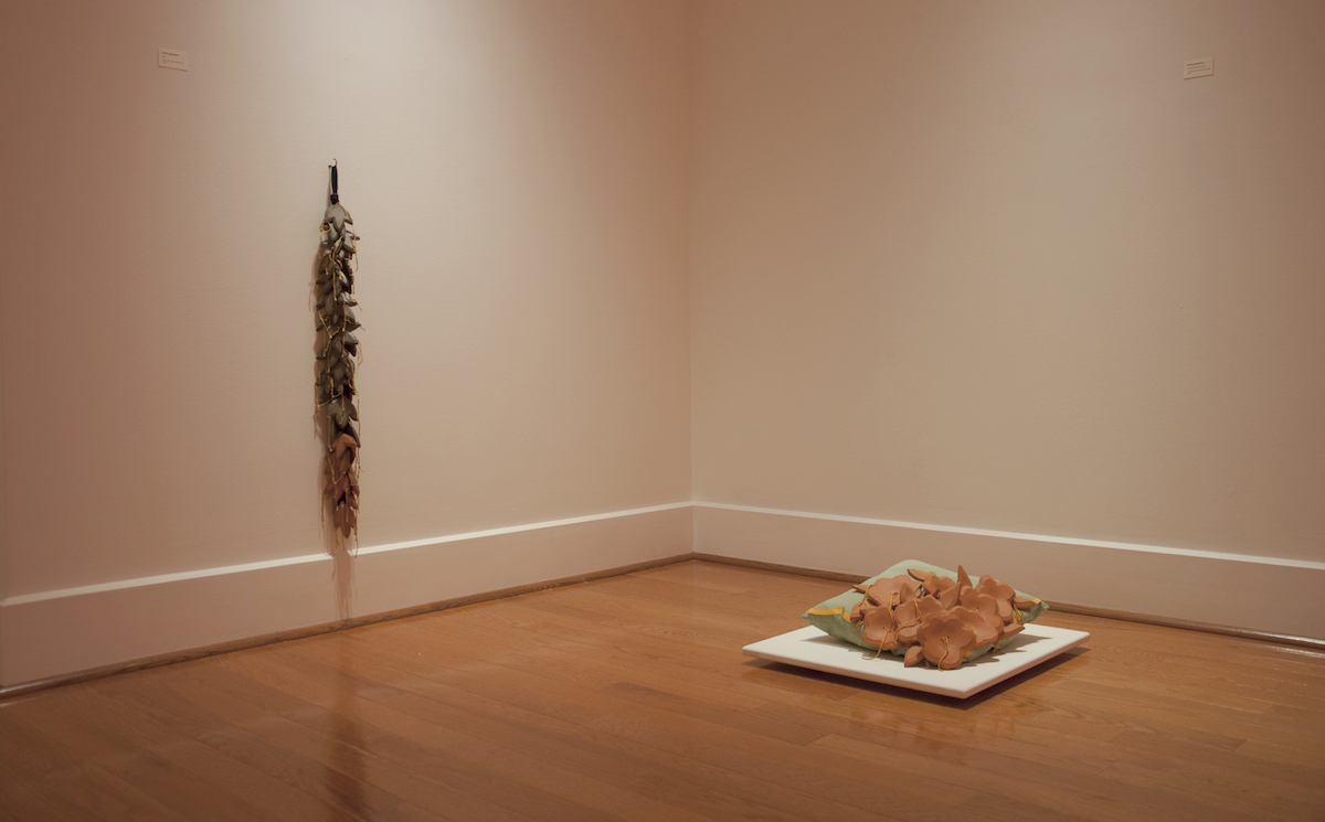 Left: Die, 2019, 37" x 4" x 4", reduced terra-cotta, cotton, floss, hook. Right: Lay Your Pretty Little Head, 2019, 6" x 15" x 15", terra-cotta, painted cotton & canvas, fiberfill, floss