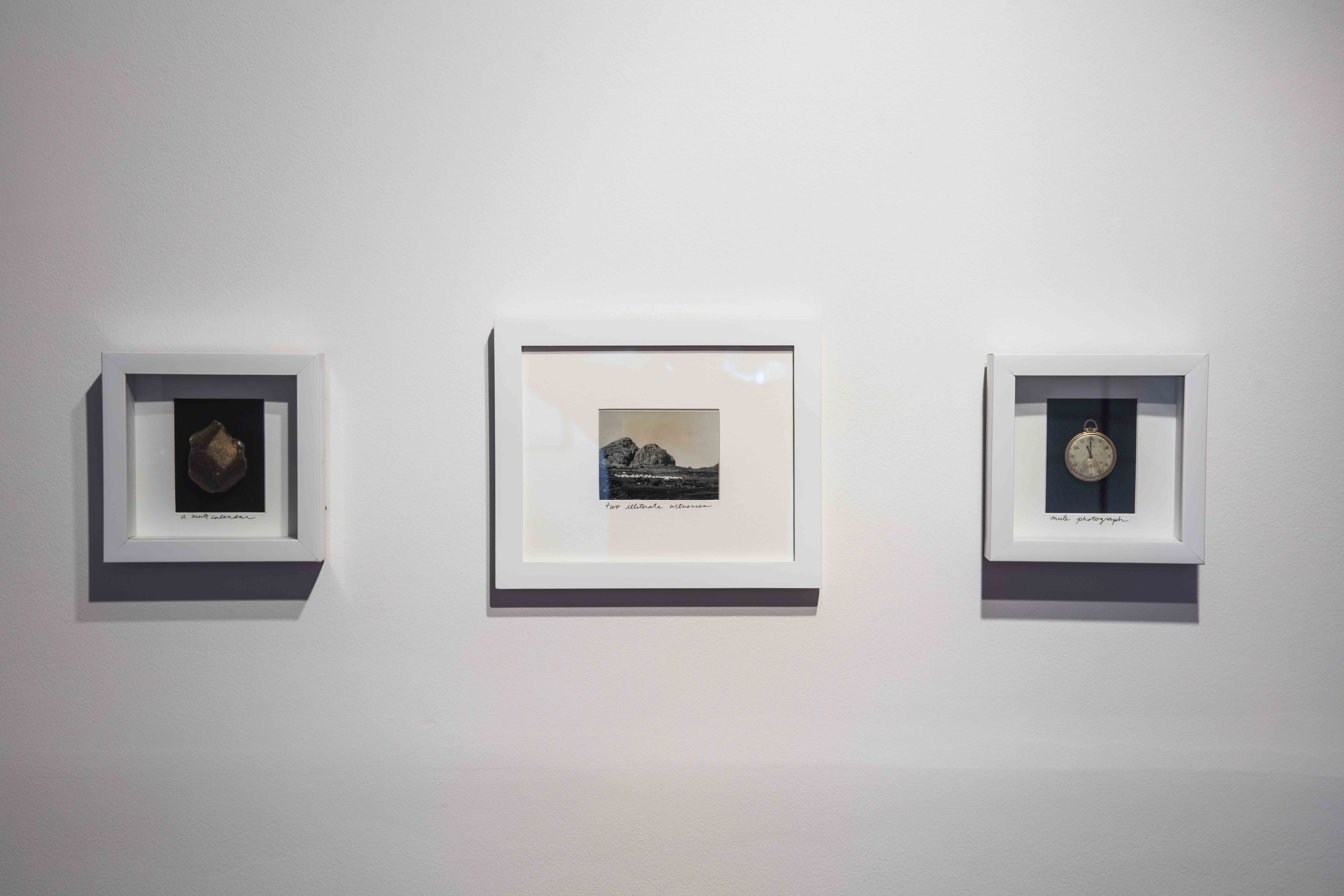 untitled (mute calendar, two illiterate witnesses, and mute photograph), 2016, triptych w/ found rock, broken pocket watch, appropriated image and ink, framed, 7.25 x 7.25 in., 11.5 x 9.5 in., 7.25 x 7.25 in.  Photo Credit: Brian Fitzsimmons, courtesy of the Contemporary Austin