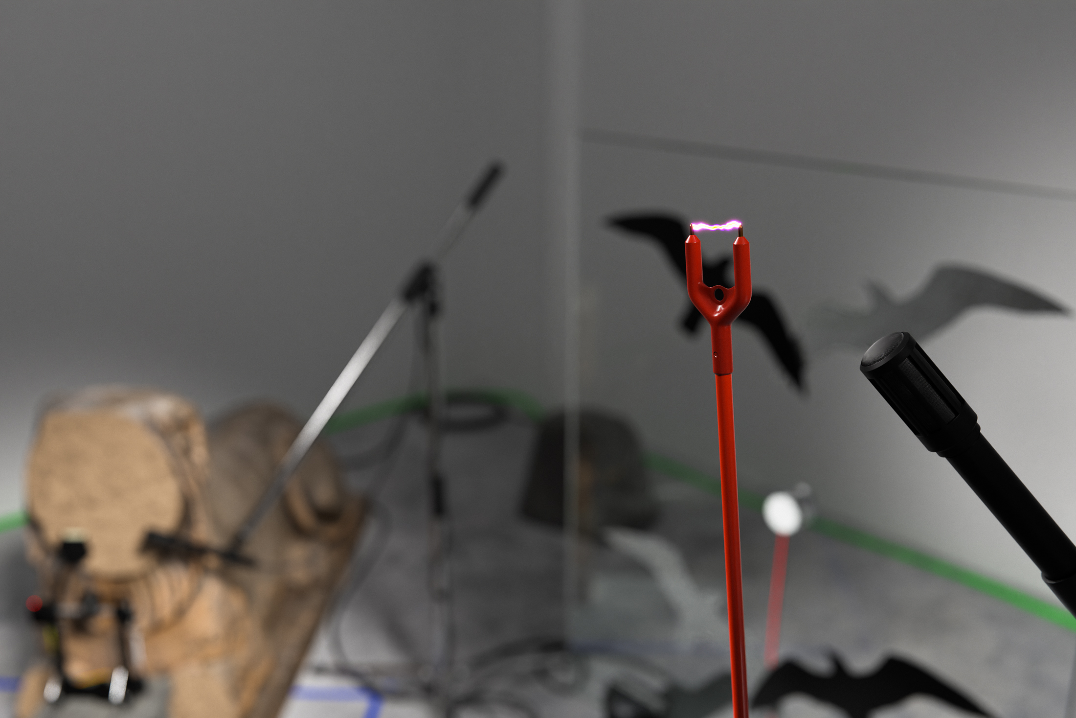 Beasts without number, 2022, defaced garden statue, cattle prod, transducer mic, kick drum pedal, servo motor, car amplifiers, cinderblock, vises, glass, anti-collision decals, arduino controllers, mics, mic stands, faux rock speakers, cables, tape, dimensions variable