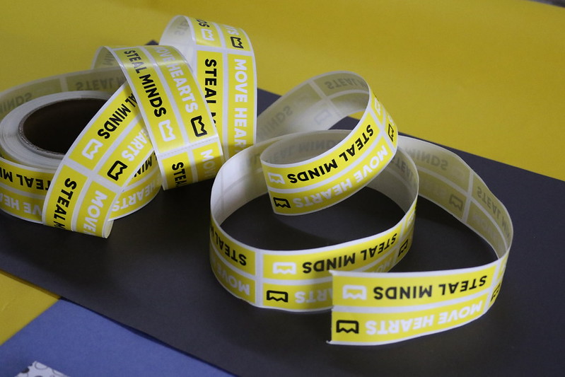 Rolls of stickers staying 'move hearts, steal minds.'