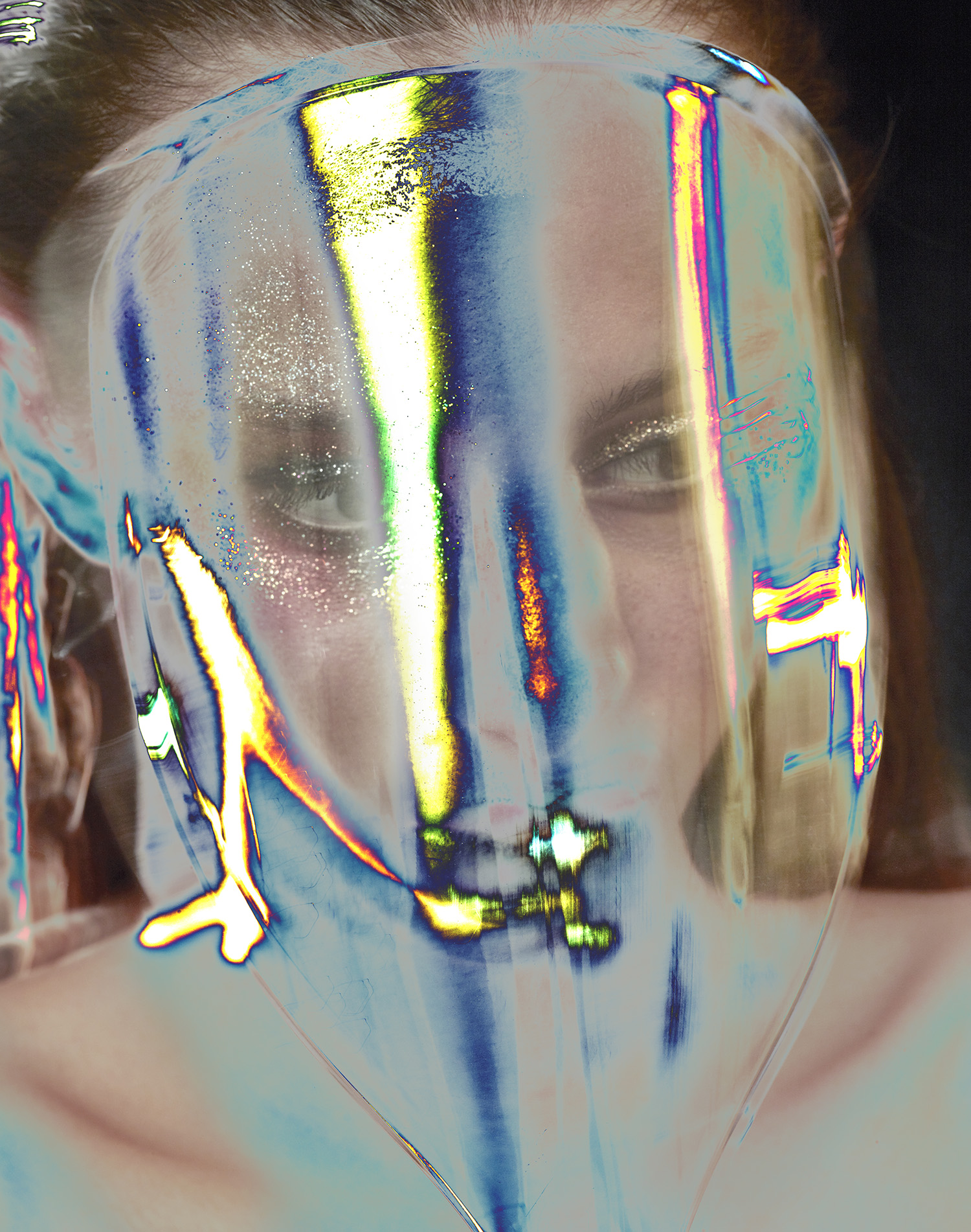 KMA photographer Daniel Schweizer shoots a photo of a woman wearing glitter eyeshadow and colorful lights covering her face