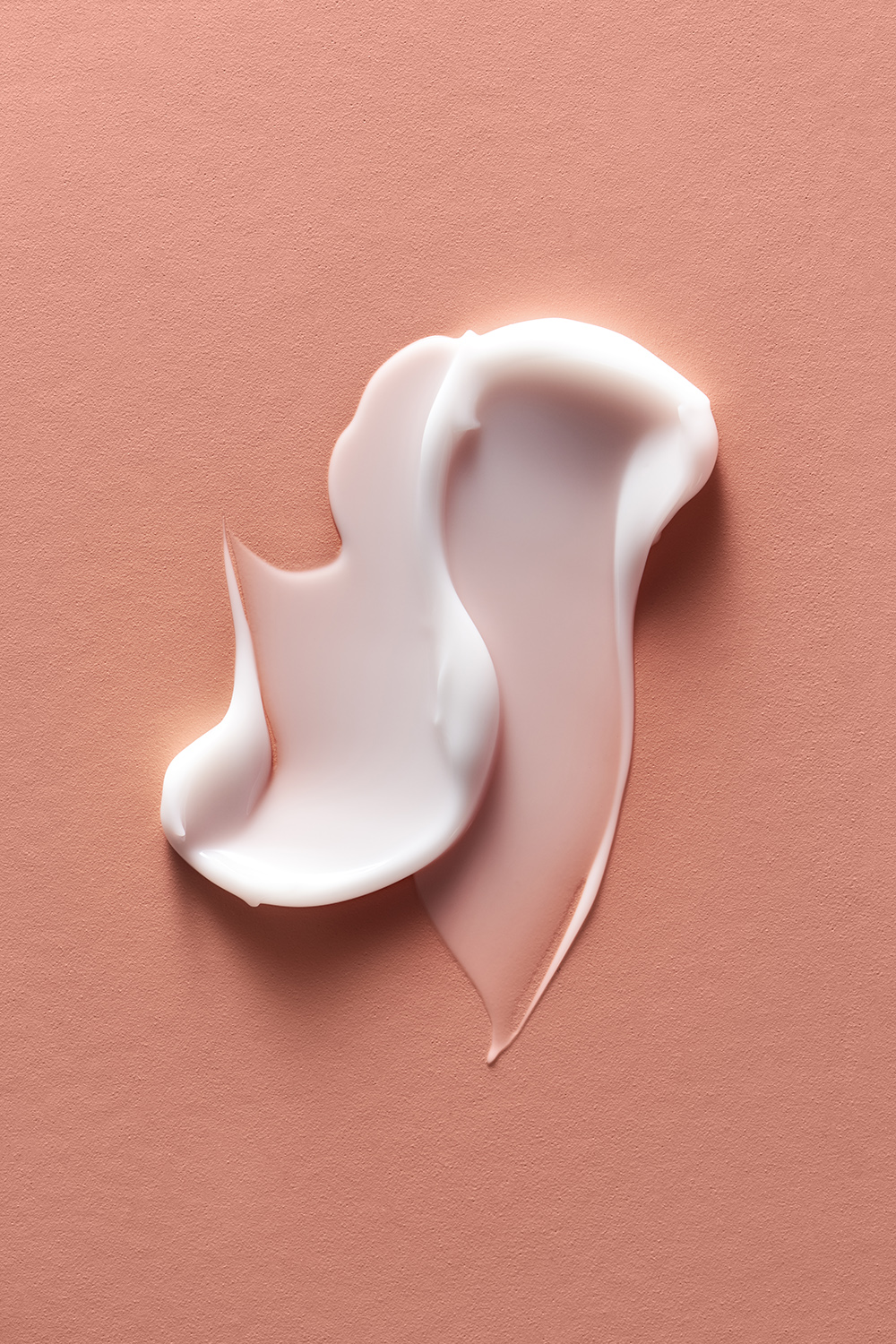 KMA photographer Mattias Nyhlin photographs creamy pink lipgloss smeared on pink background for Kicks