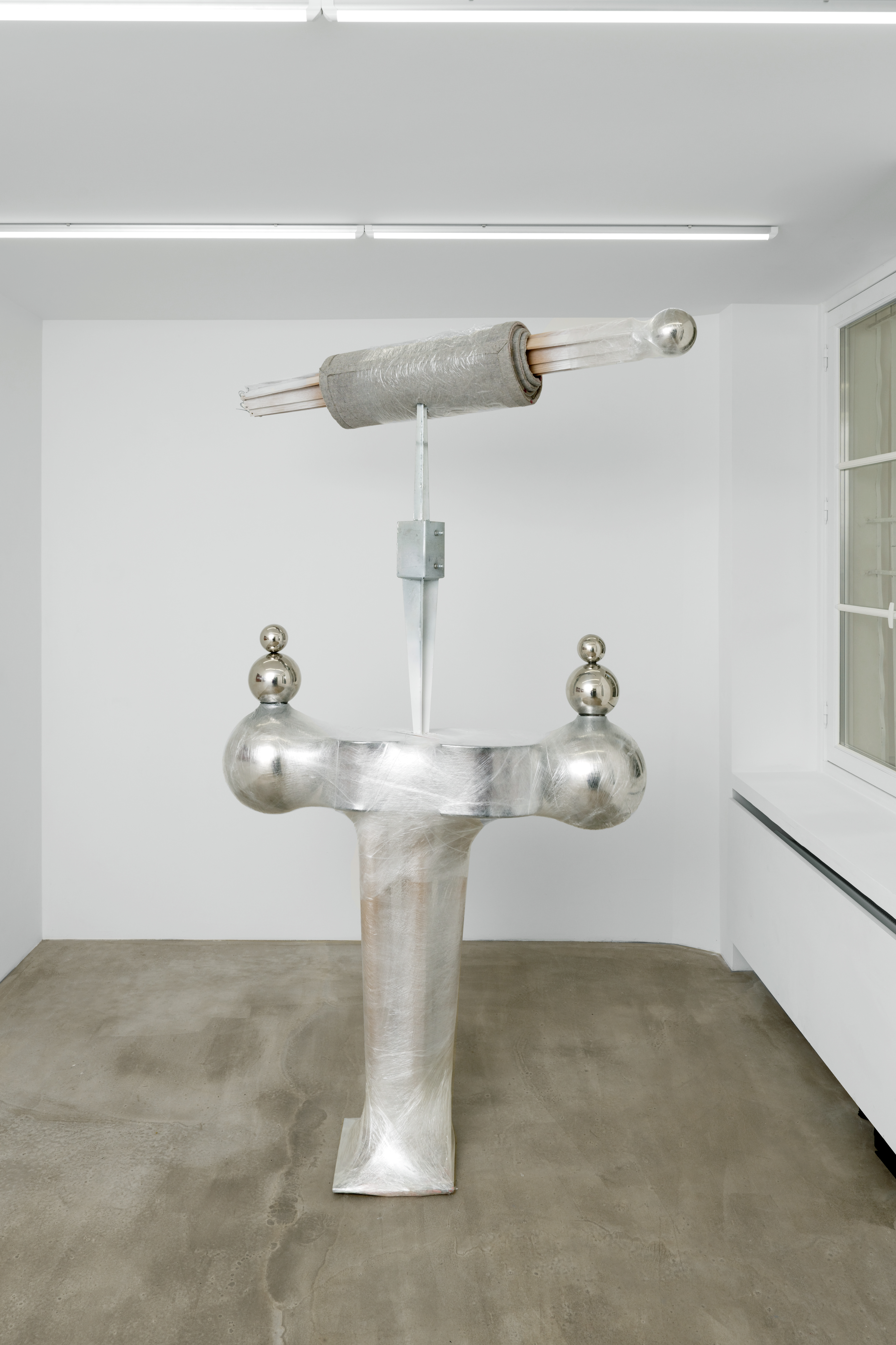 Fuga, 2023 Broken cello, oak slats, rug, cellophane, chrome plated-steel, cardboard, spray paint, fence post spikes 149 x 221 x 45cm