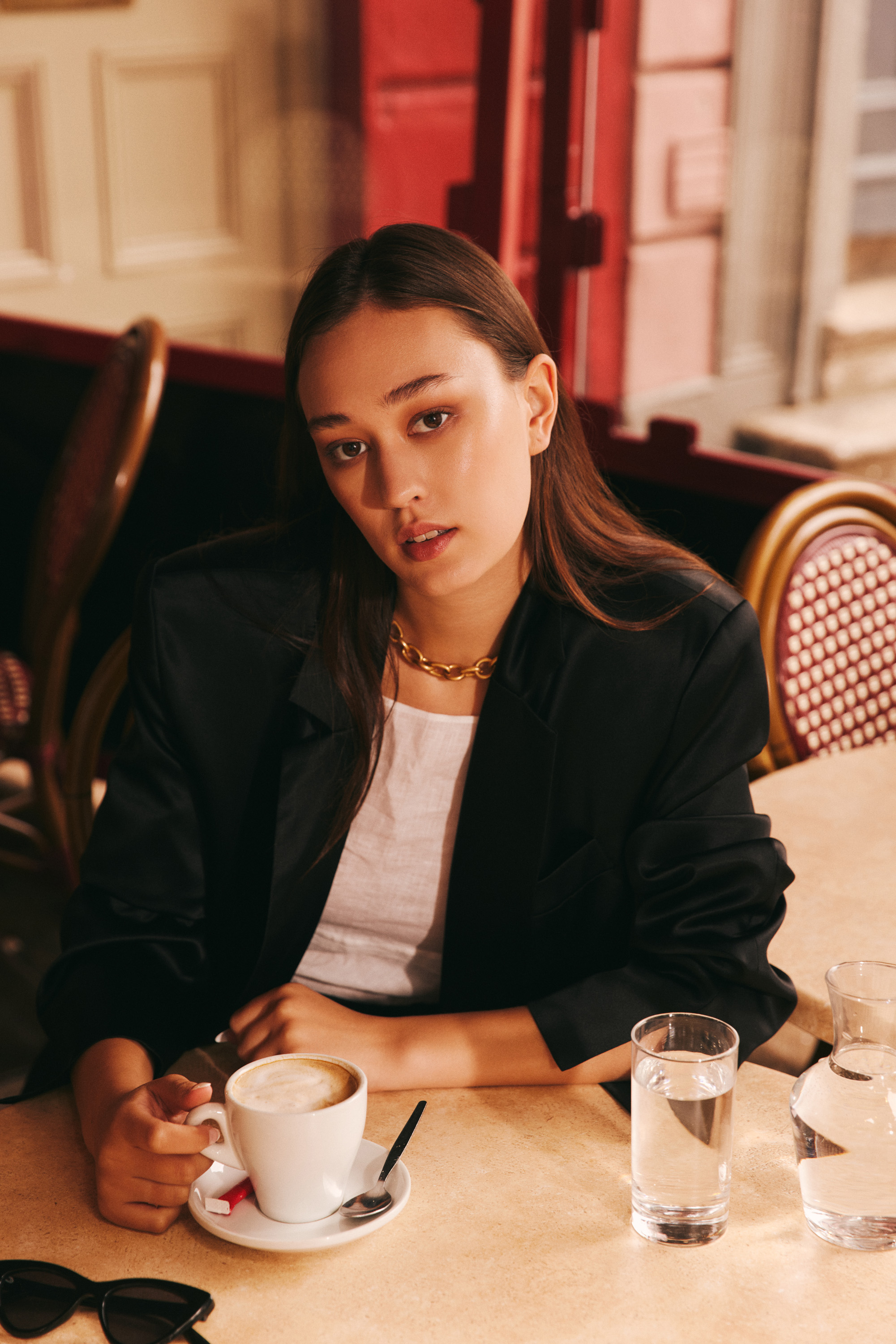 Luxurious fashion editorial photoshoot in Dublin, Ireland, featuring a stunning model in vintage clothes. Photographed in the city's trendy French cafes, this photography showcases the elegance of high-end fashion and the charm of vintage clothing. Captured by a skilled photographer, this editorial is sure to impress.