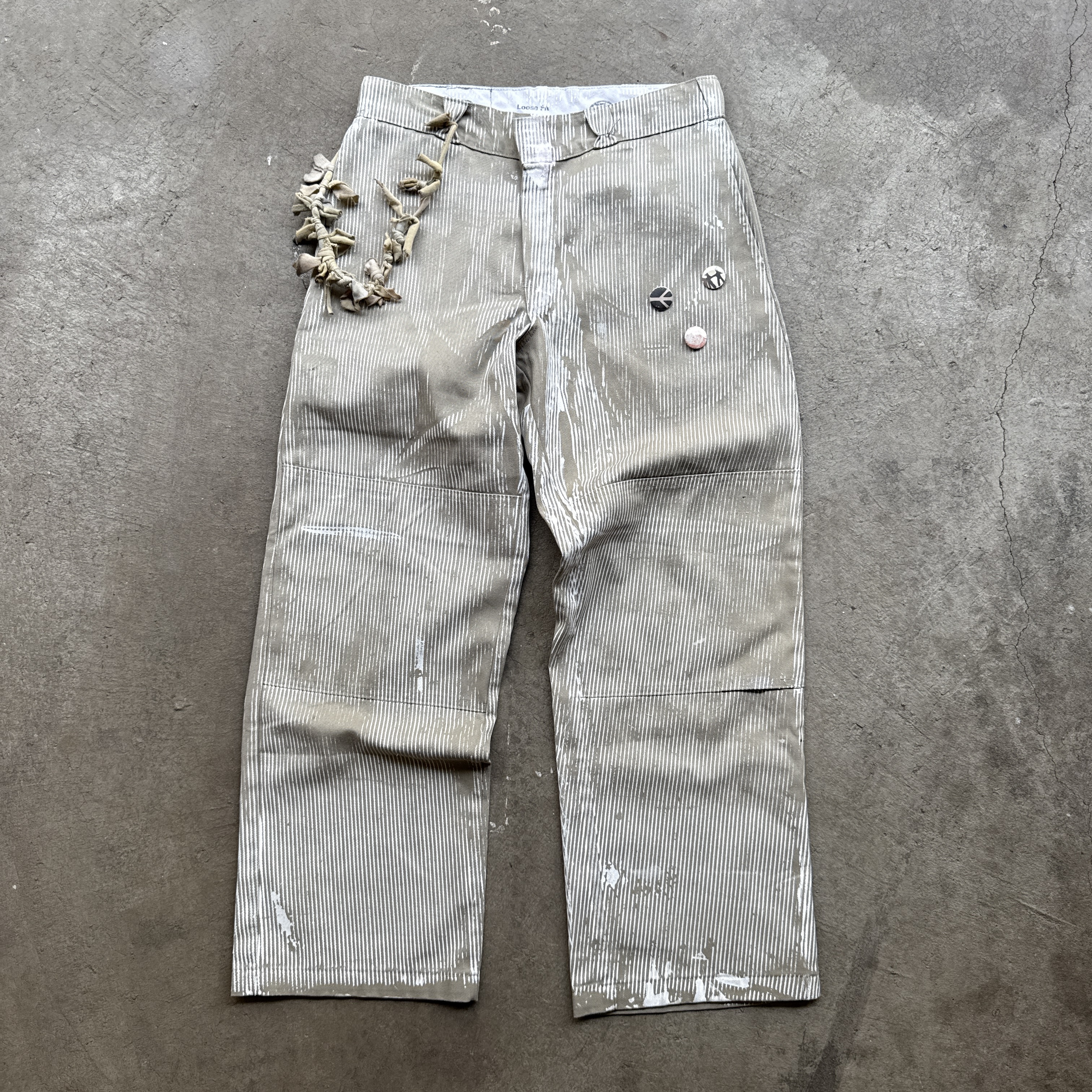 reclaimed vintage surplus denim screen printed with pinstripes in textile dye. tailored for straight/wide fit. fitted with custom keychain, scrap chain, and leather patches