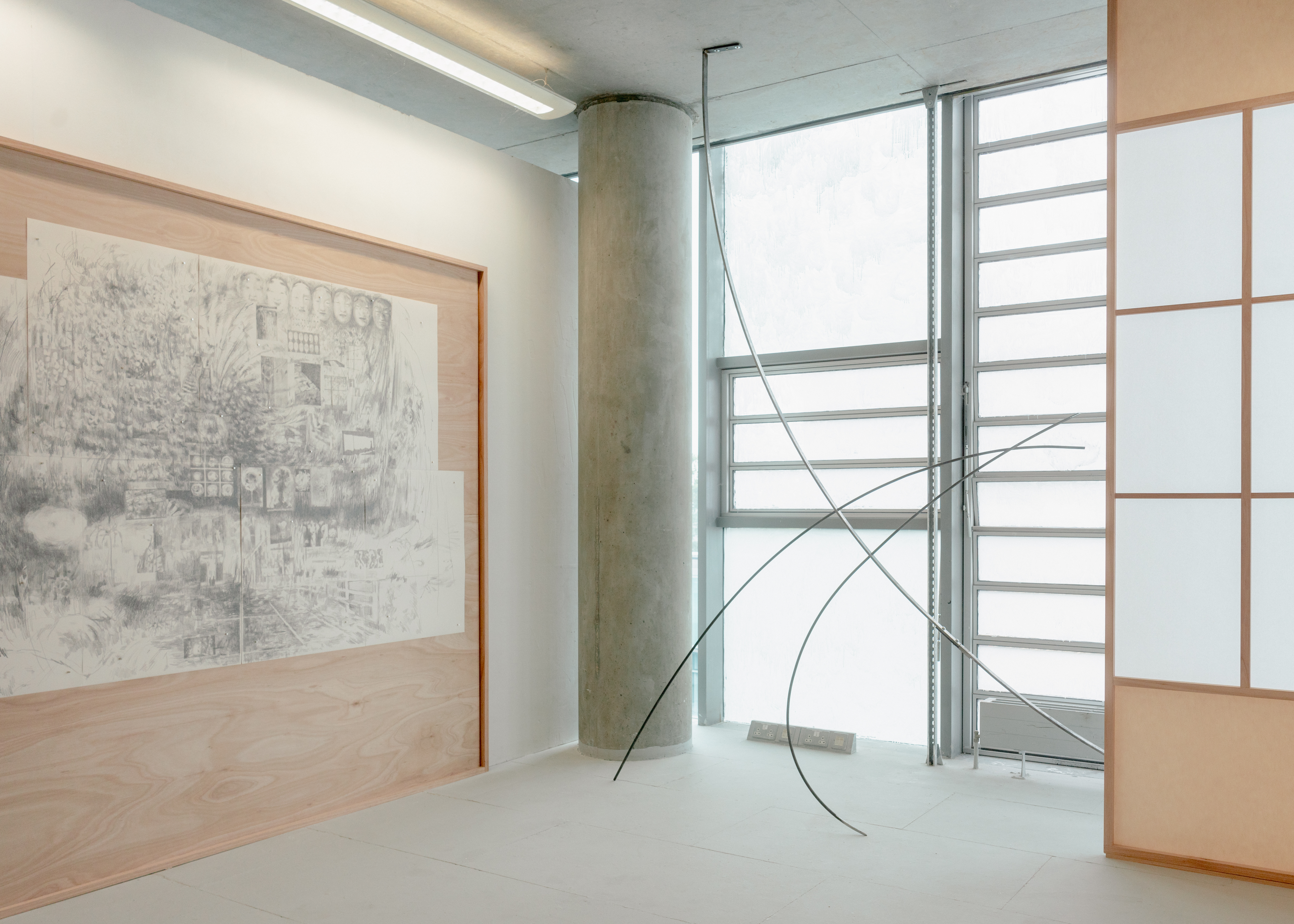 Installation featuring The Nightmare (distant deeps or skies), 2025. Graphite on drawing paper with magnets in plywood and red grandis artist’s frame, and Bloom II, 2025. Steel, hardware.
