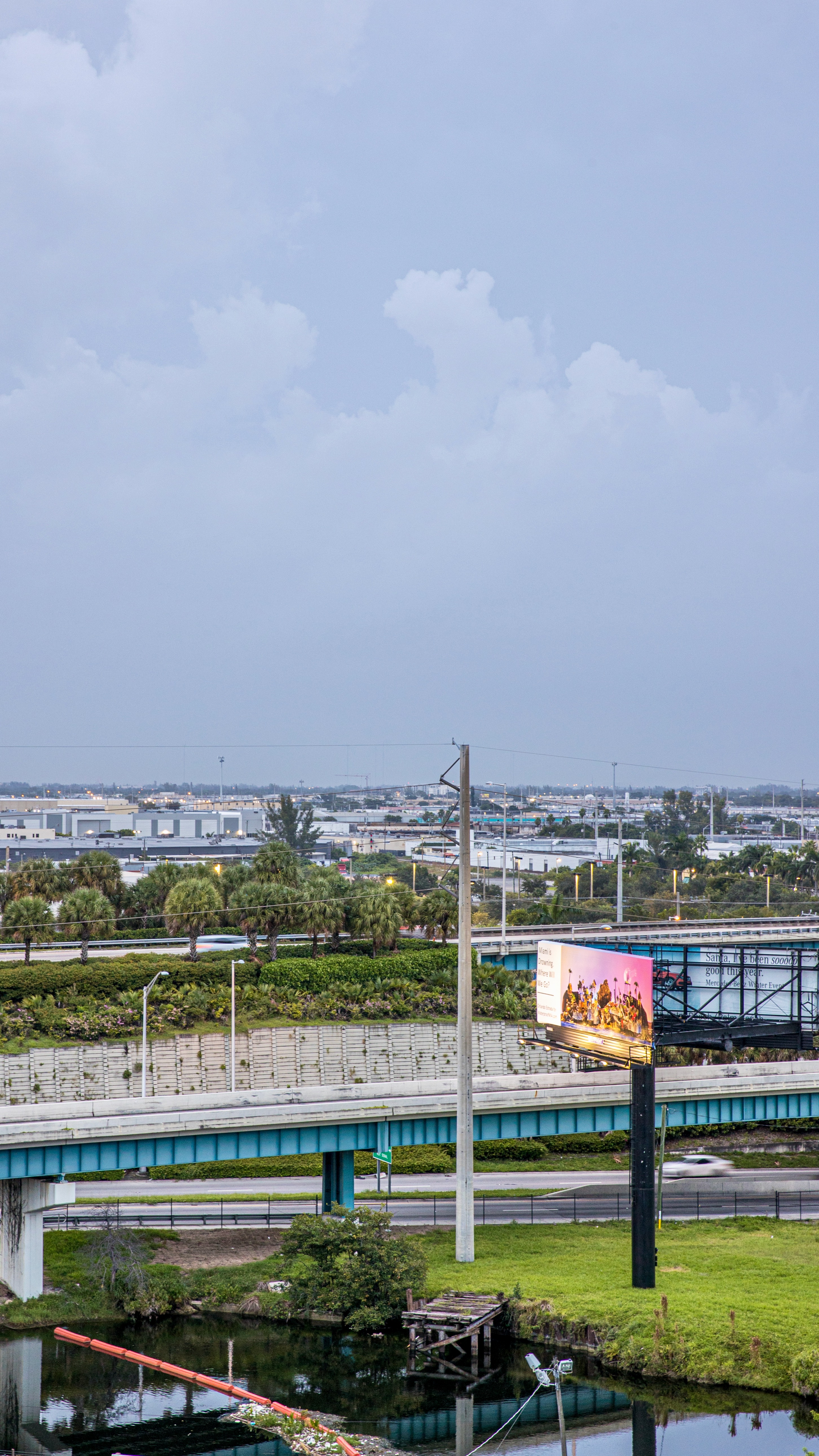 Aerial view of Orlando Estrada’s billboard “Dear Miami”, pictured alongside a highway.