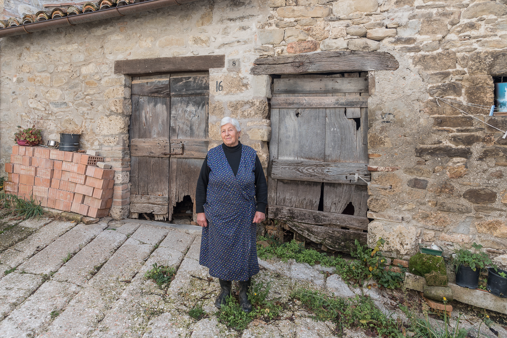 Cese, Montemonaco, Sibillini Mountains, Marche, Italy. November 2017. It's already been a year and Cese, one of the villages of Montemonaco most affected by the earthquake, is all surrounded by red nets. All the houses are now uninhabited and uninhabitable. This could make one think that there is no life. Instead, walking through the small streets you can see small plots of cultivated land, you can hear the animals and above all a bustle of cars that park on the dirt road, at the edge of the red zone. They are the inhabitants of the four families who lived in Cese before the earthquake and who return almost every day to take care of the animals and the land. It is not known if and when Cese will be rebuilt, but until now its inhabitants have not abandoned it: here life goes on and every morning little Cese awakens.