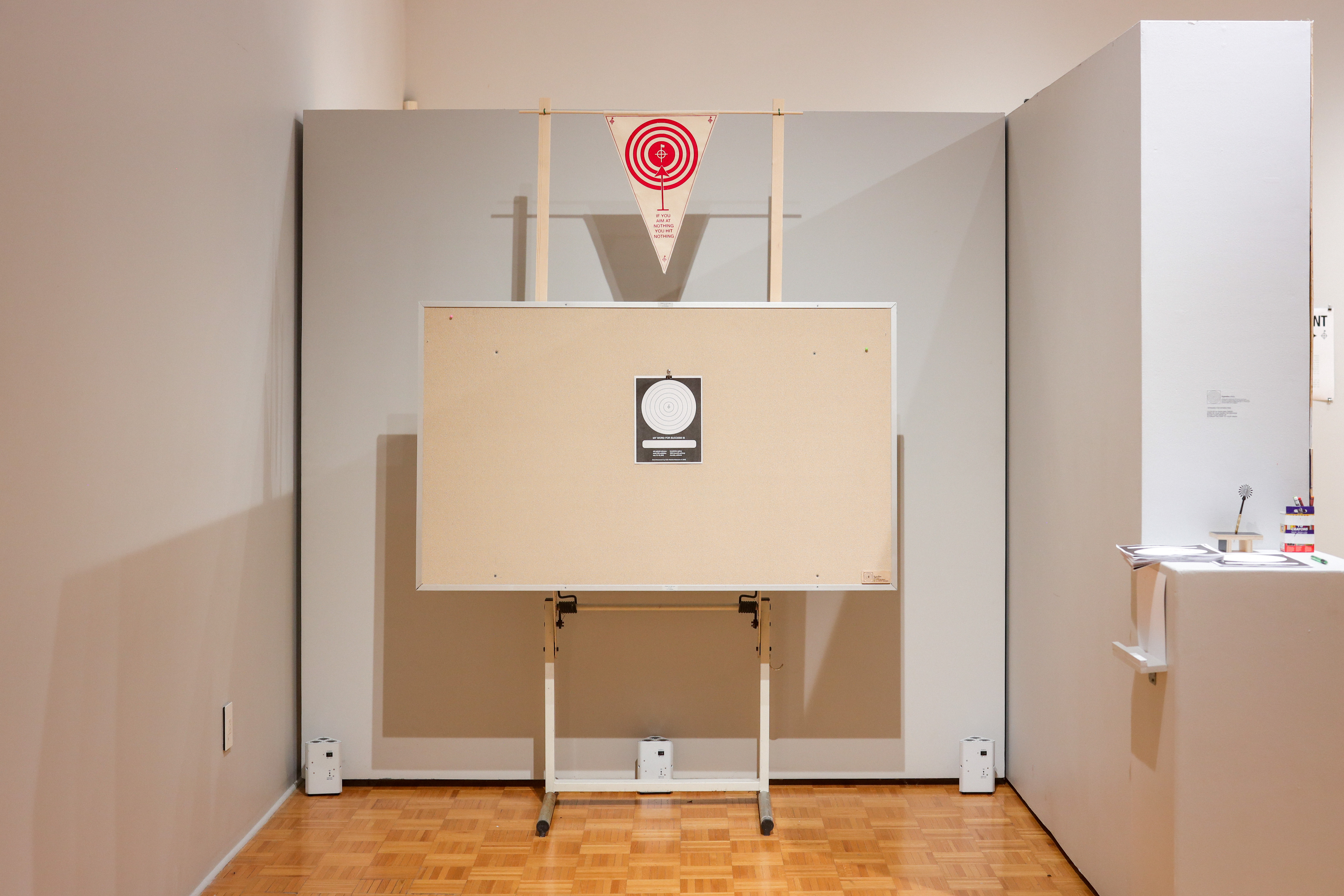 Pygmalion is a found object interactive piece that asked viewers to write what their interpretation of 'success' is and throw a dart at it. Accompanied by a screen-printed flag at the top saying, "if you aim at nothing, you hit nothing."