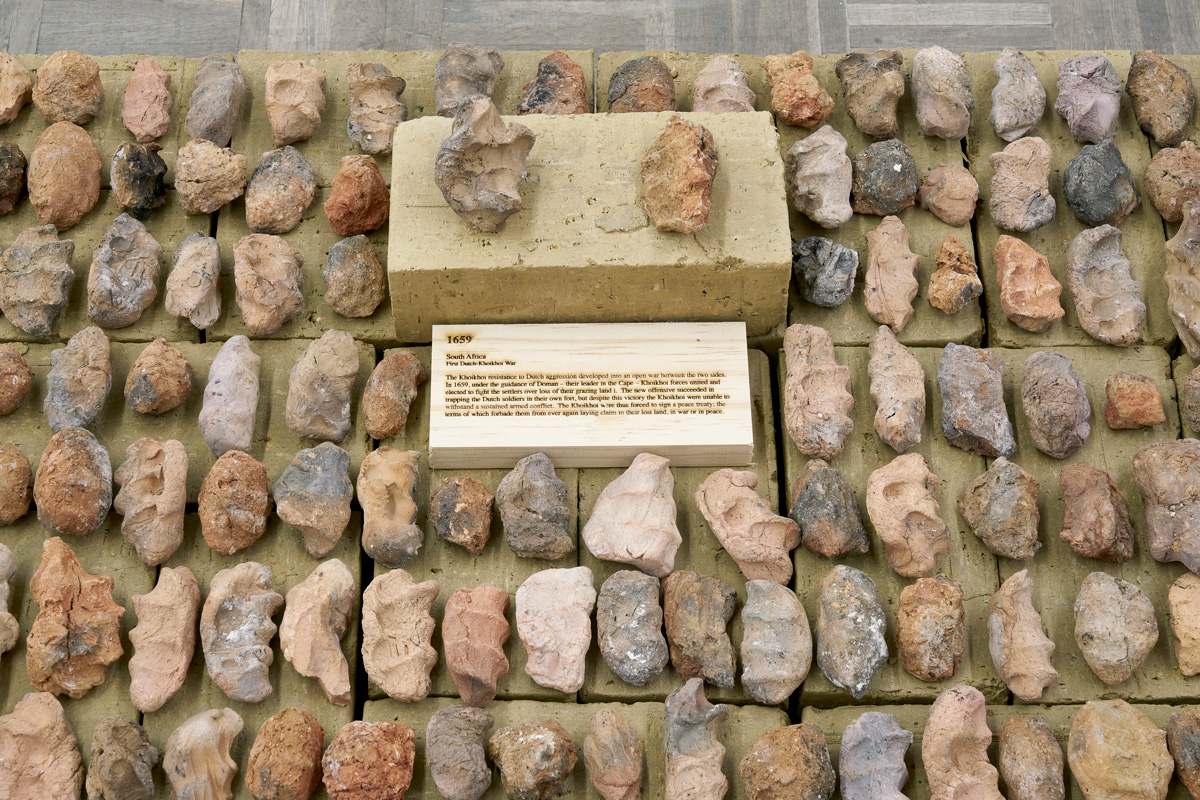 Dineo Seshee Bopape, footnotes, Lerole (2023) | Unfired clay bricks, various clays, beach gravel and sand from the Southernmost tip of Africa, pine wood plaques, approx. 30 x 90 x 300 cm