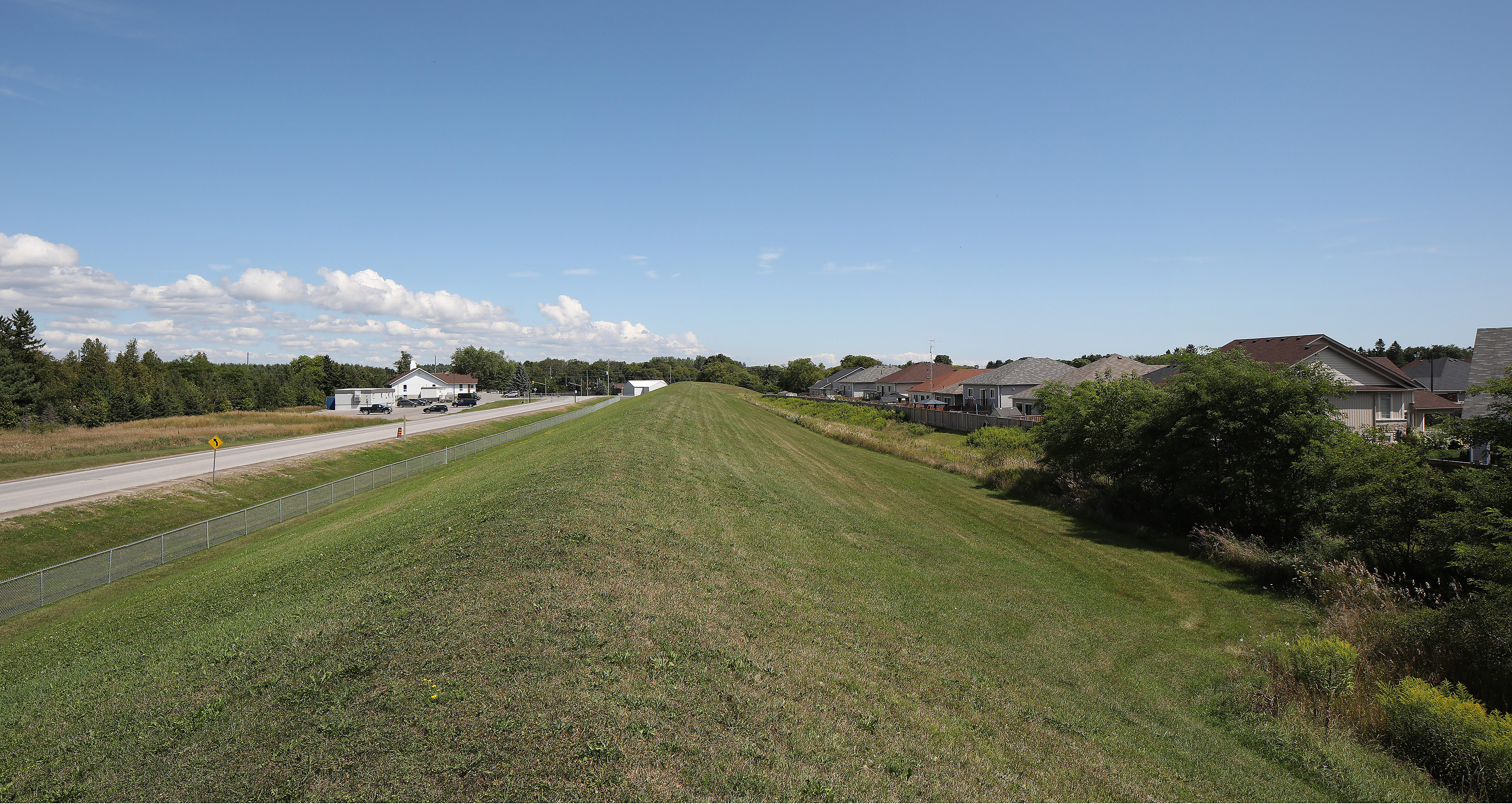 Berm, access road to mound, homes