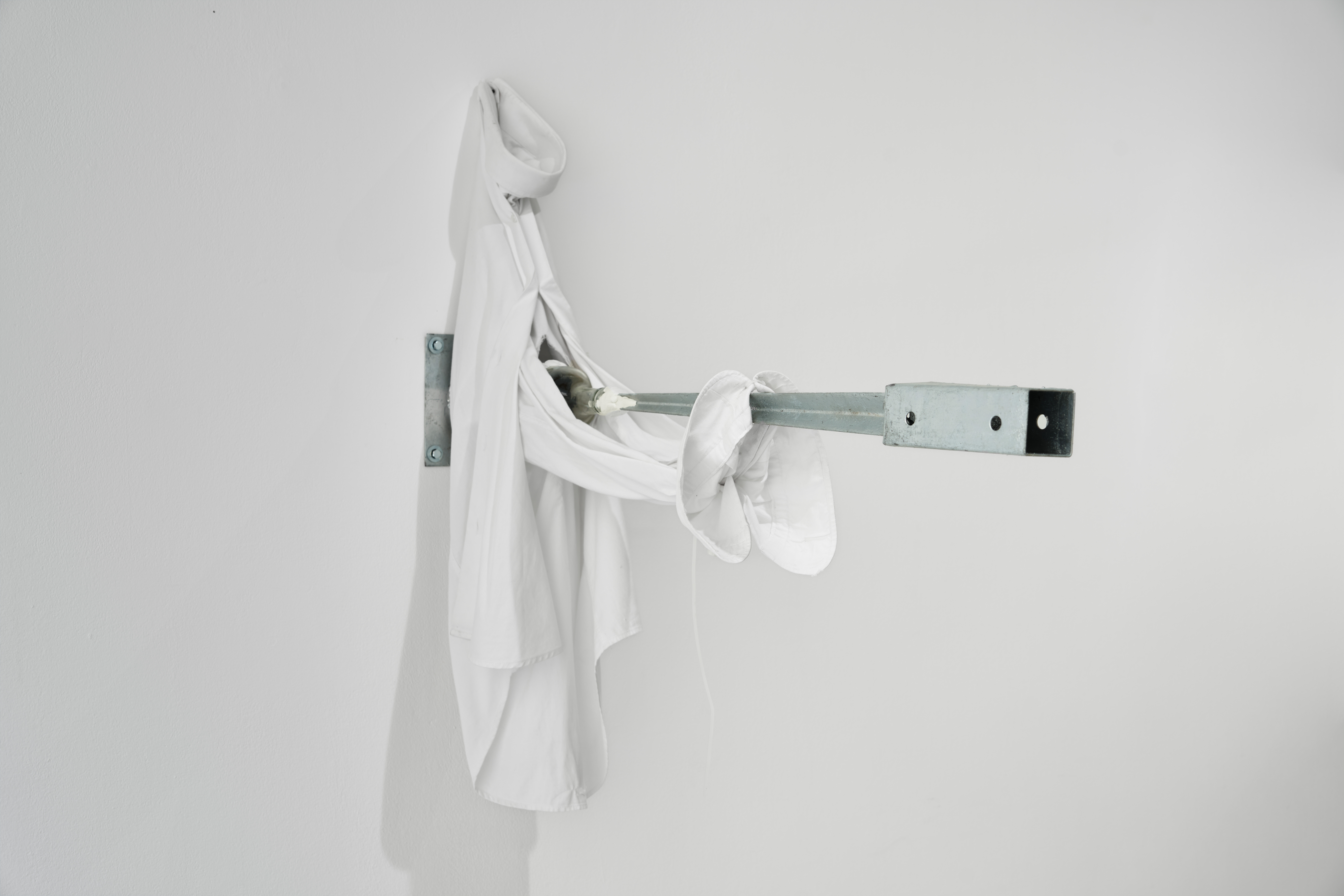 Adaptation, 2022 (White shirt, Bottle, Fencepost spike, Epoxy putty) 86.5 x 22 x 88cm shown in ‘Chômage Technique’ at Lovaas Projects.