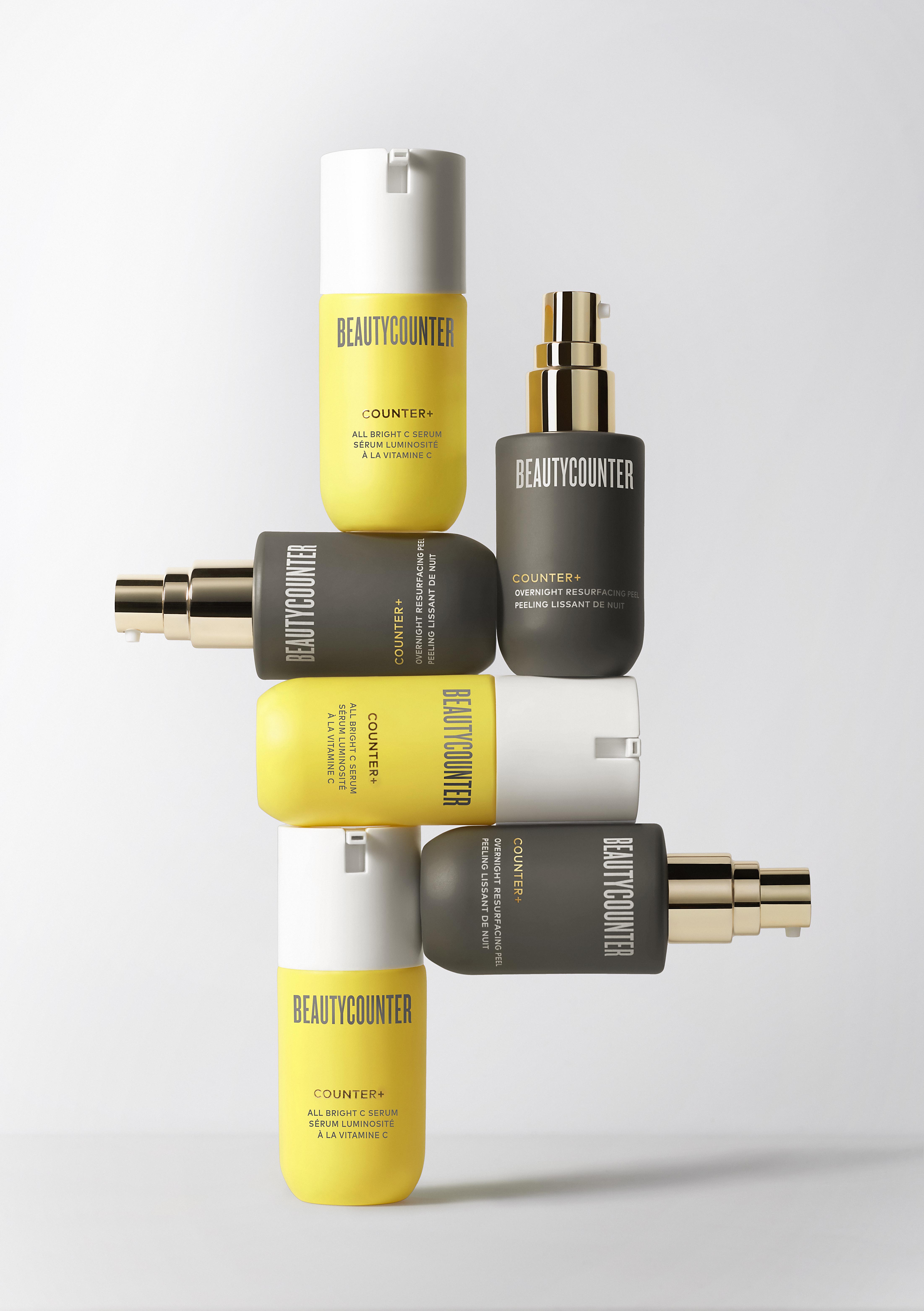 KMA stylist Sara Wacksman designs set for photo of Beauty Counter serum bottles stacked on each other with a white background