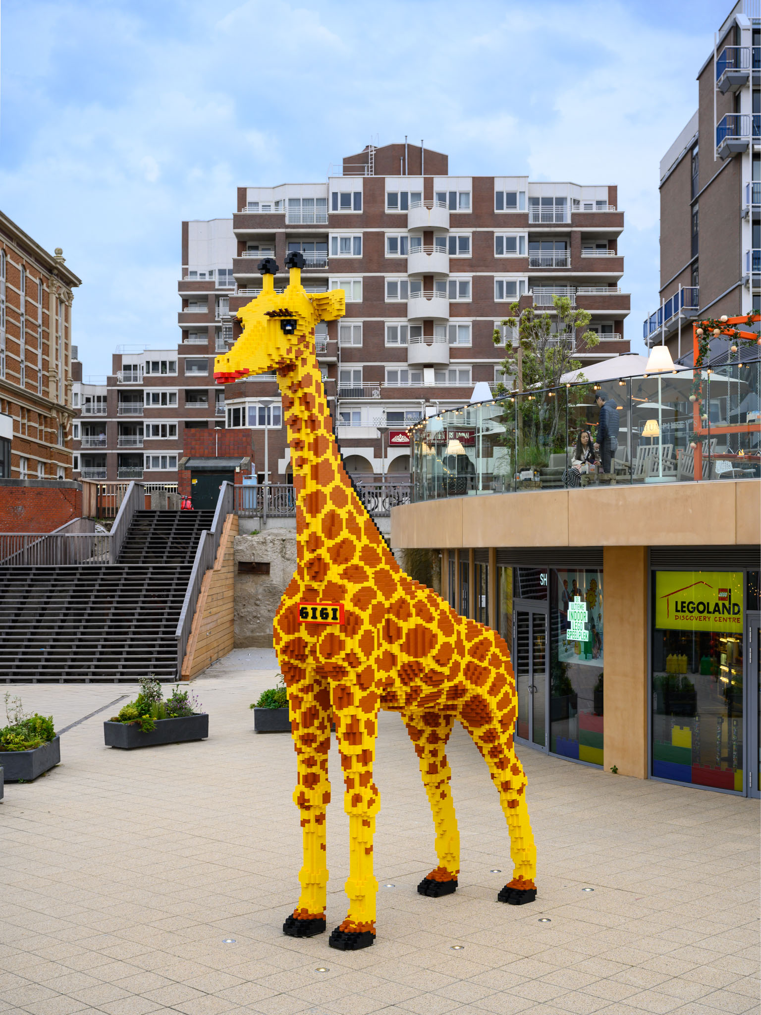 Lego Giraffe Gigi next to the new Legoland Discovery Centre.