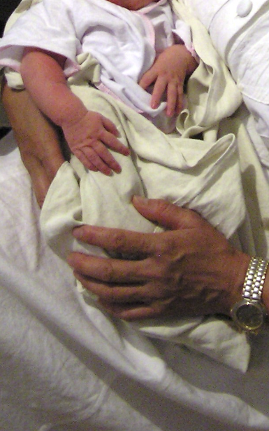 Aisha in her Grandmother's arms.