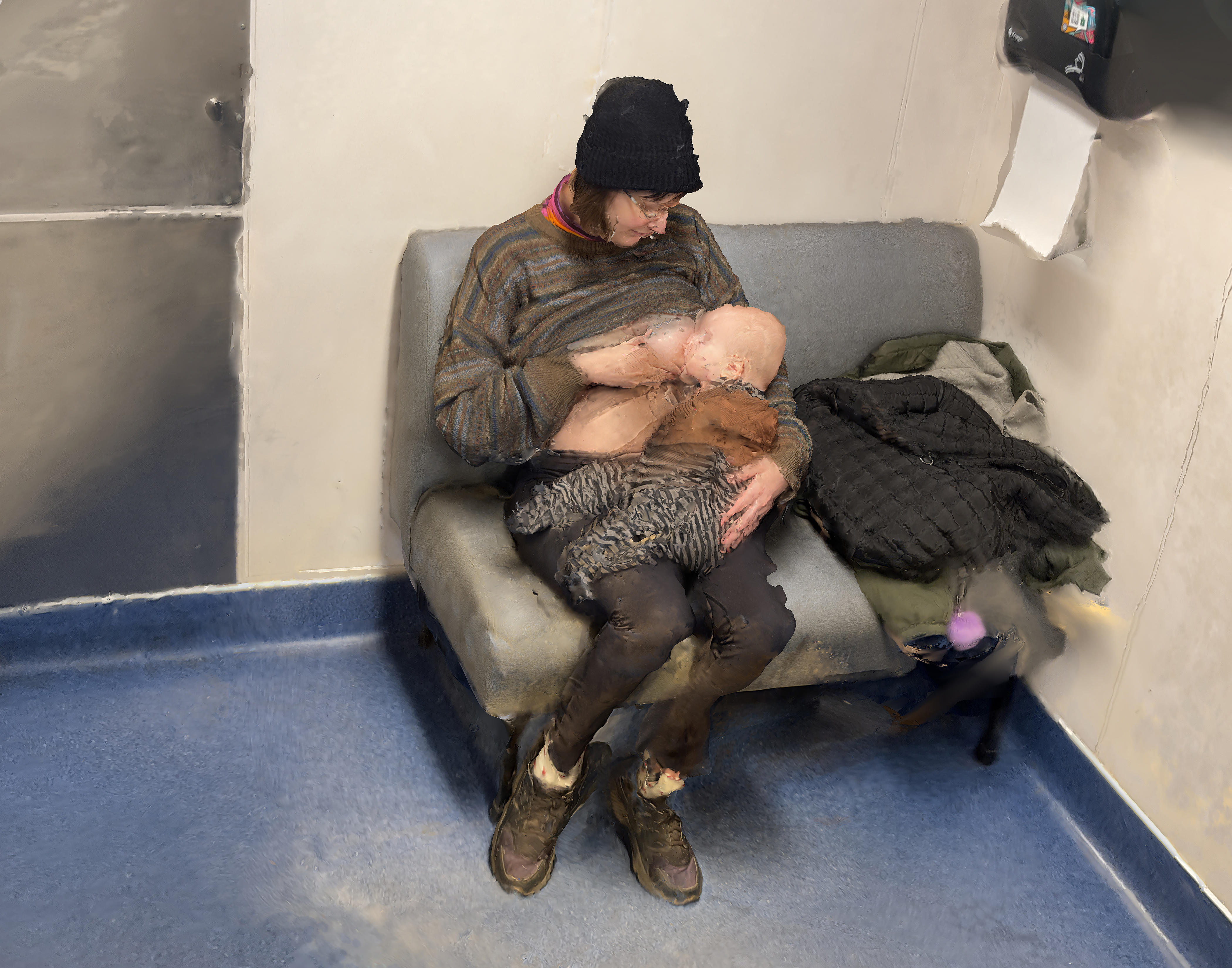 In a sterile, brightly lit room, Olivia sits on a grey bench nursing her baby. Her posture is curled inward as she looks down at the child. Behind her lies a pile of jackets and a black diaper bag, a small refuge in a cold, impersonal space.