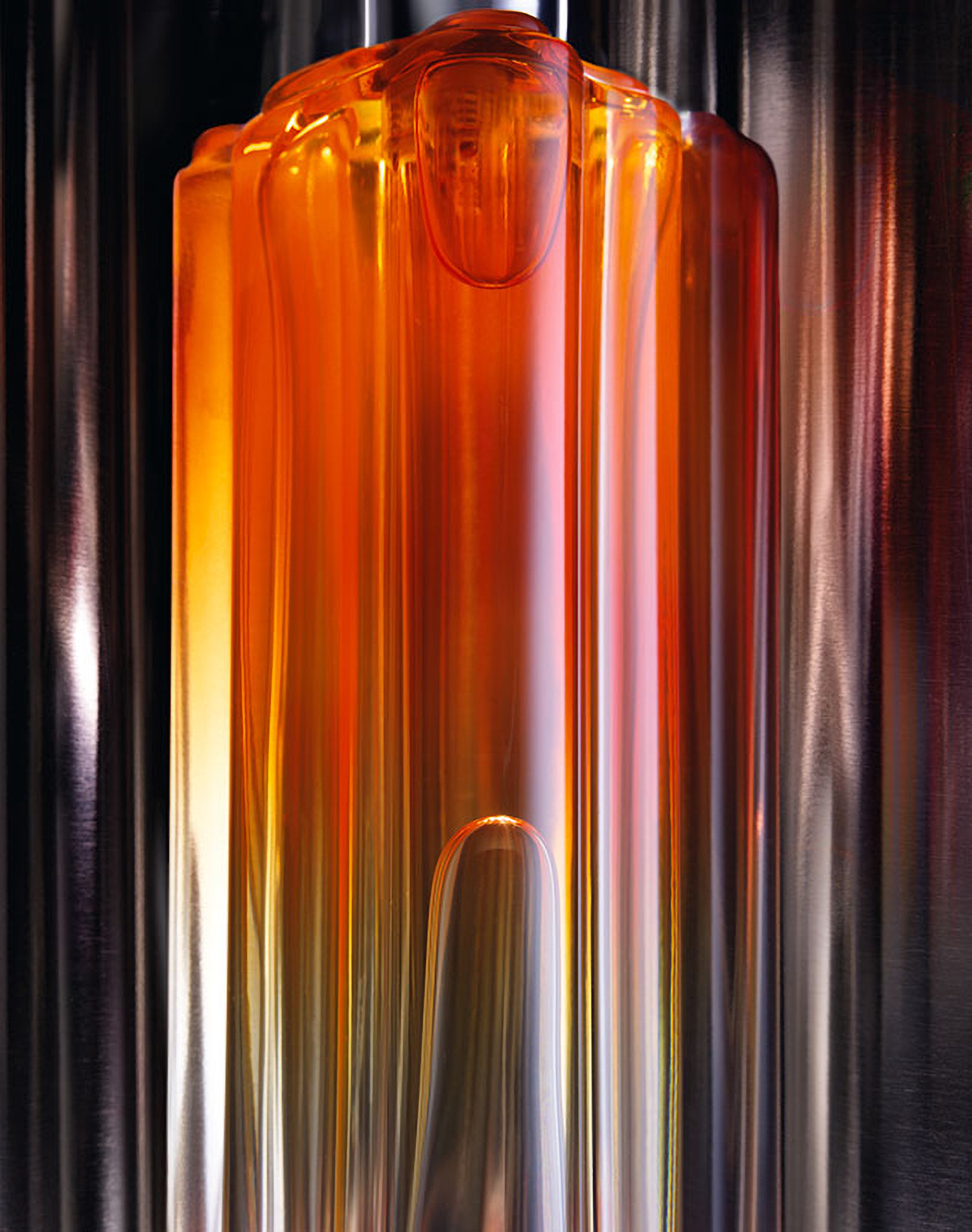 Elongated lighting creates a fascinating effect on a glass fragrance bottle shot by Still Life Photographer Daniel Schweizer for Gloss