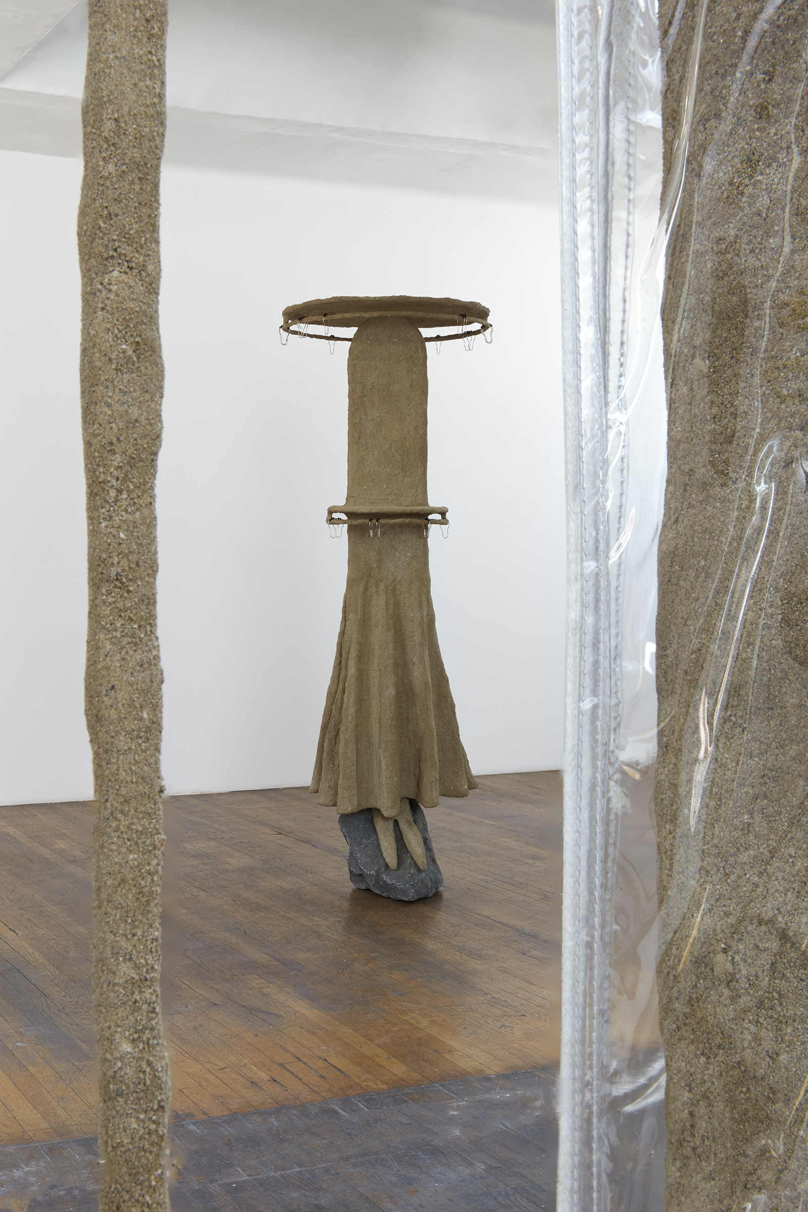 Thirst Trap (installation view), 2021, steel, sand, polymer, burlap, rock, vinyl, shower curtain hooks, toothbrushes