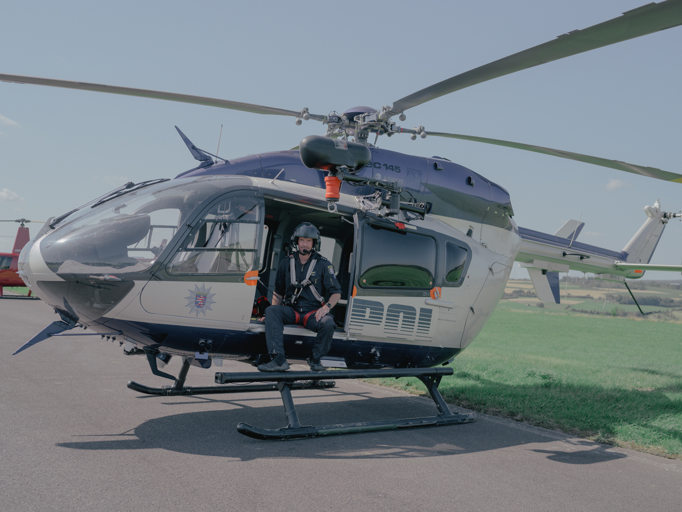 Stefan Bustert, helicopter pilot of the Hessia Police Air Squadron, poses for a portrait at Bad Neuenahr-Ahrweiler airfield. He helped evacuate people and transported materials to remote villages. Despite his 20 years of professional experience, it is an unusual situation for him. Bad Neuenahr-Ahrweiler, July 18, 2021
