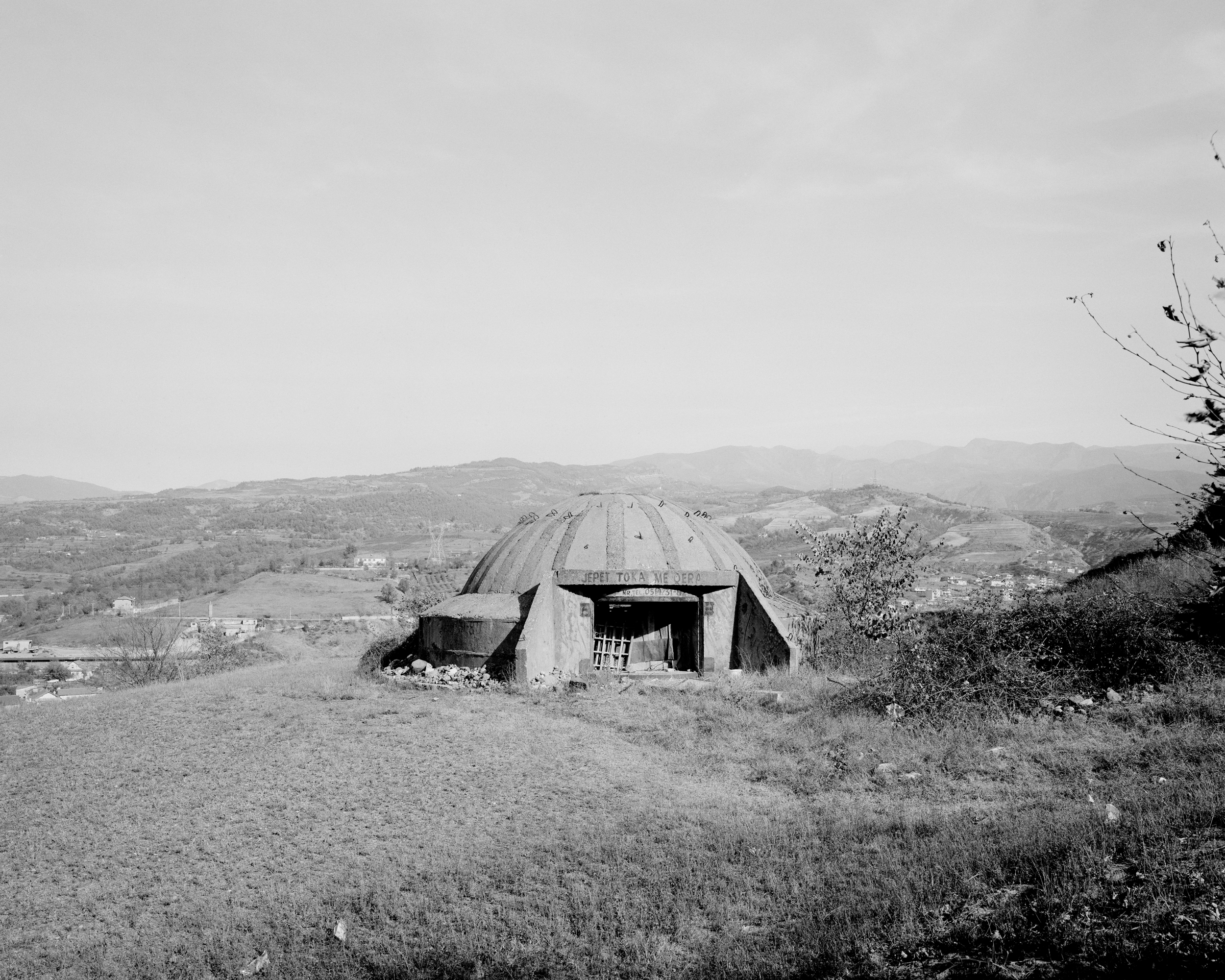 The writing on the bunker says: "The land is for rent". Librazhd, central Albania
