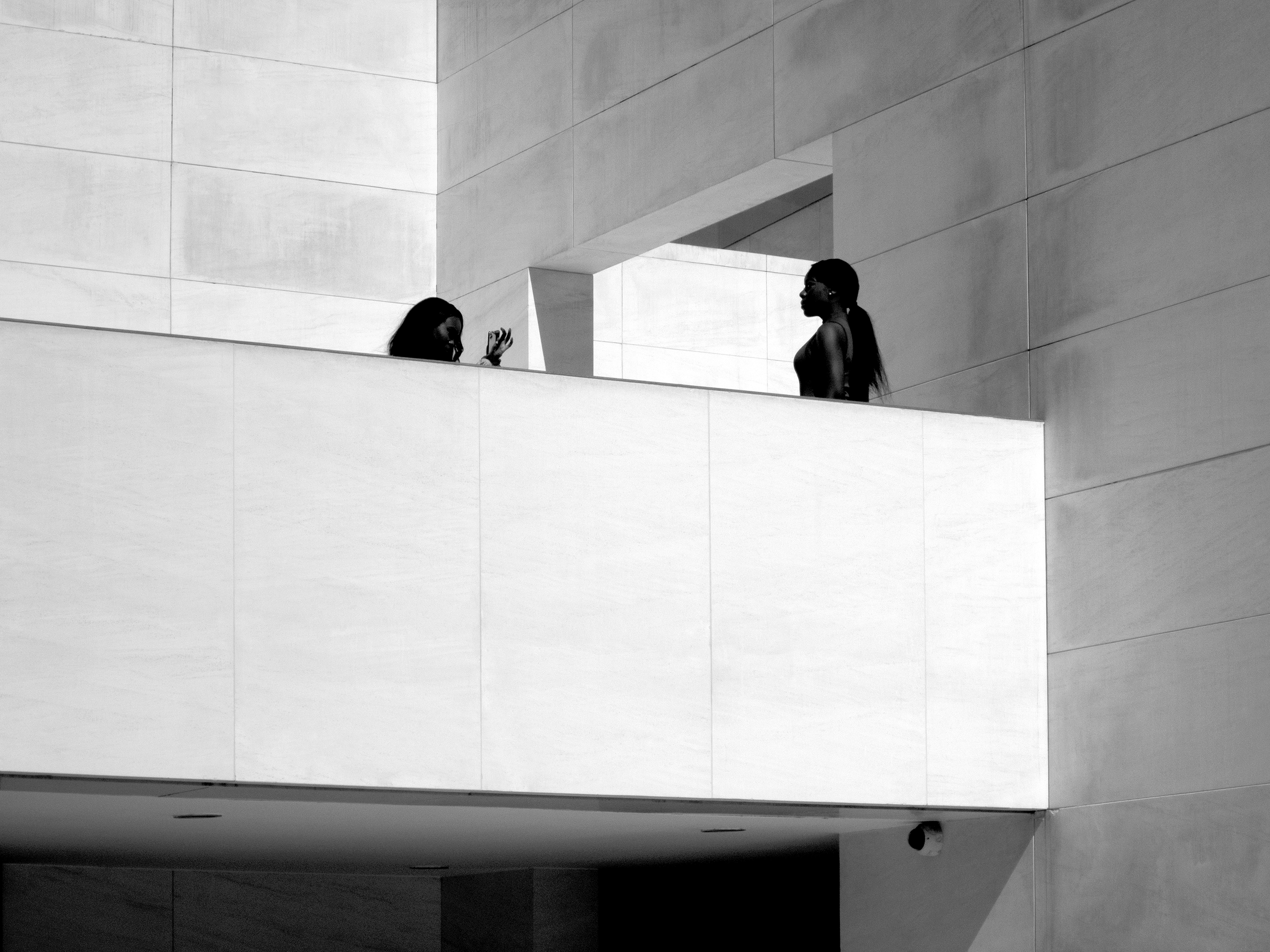 Tourists taking photos outside the CaixaForum Center Barcelona, Spain, 2022photography, bw, single