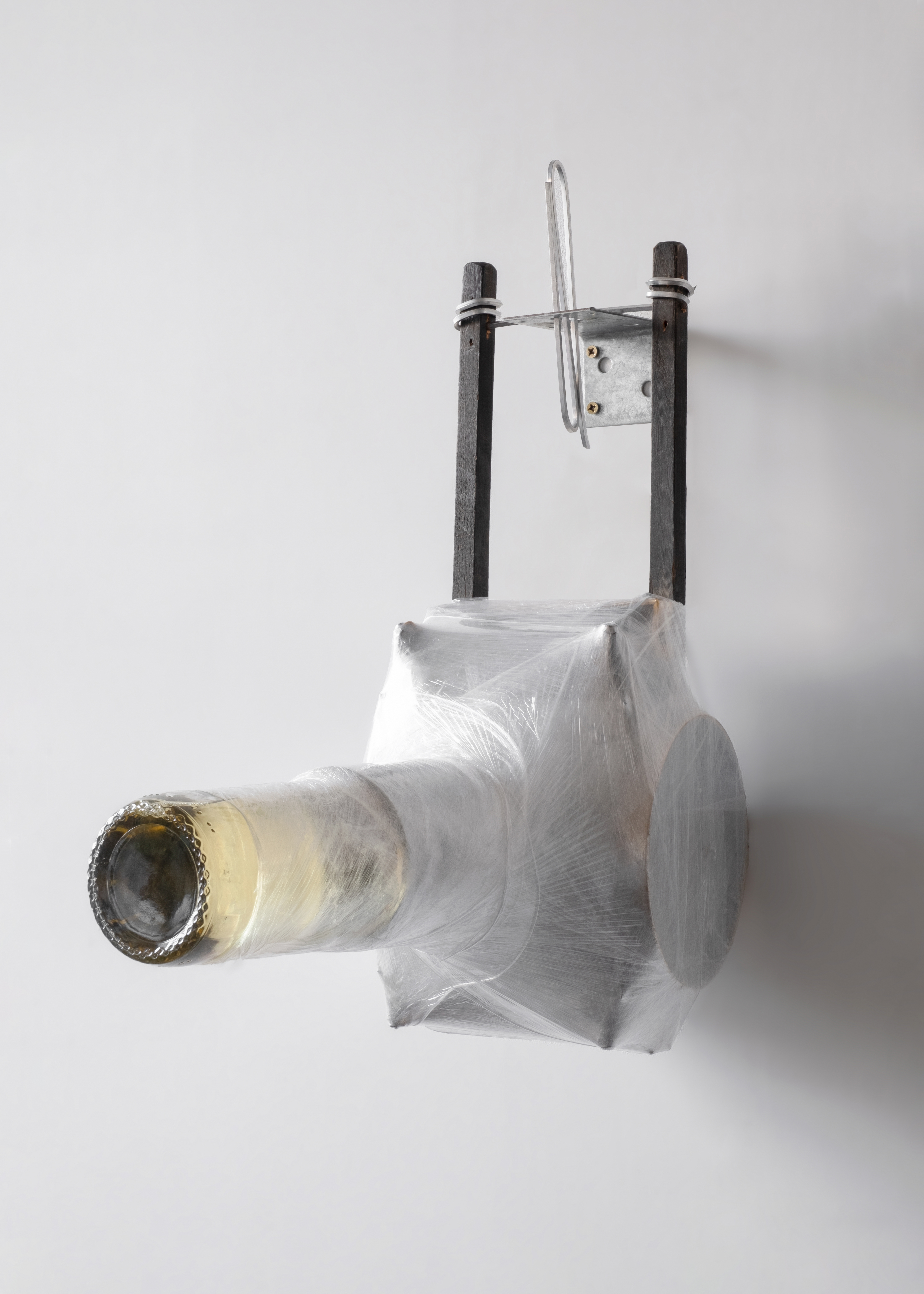 Thrill, 2022, Bottle of Wine, Fence Post base, Shrink wrap, Found Wooden Carriage 45 x 22 x 48 cm