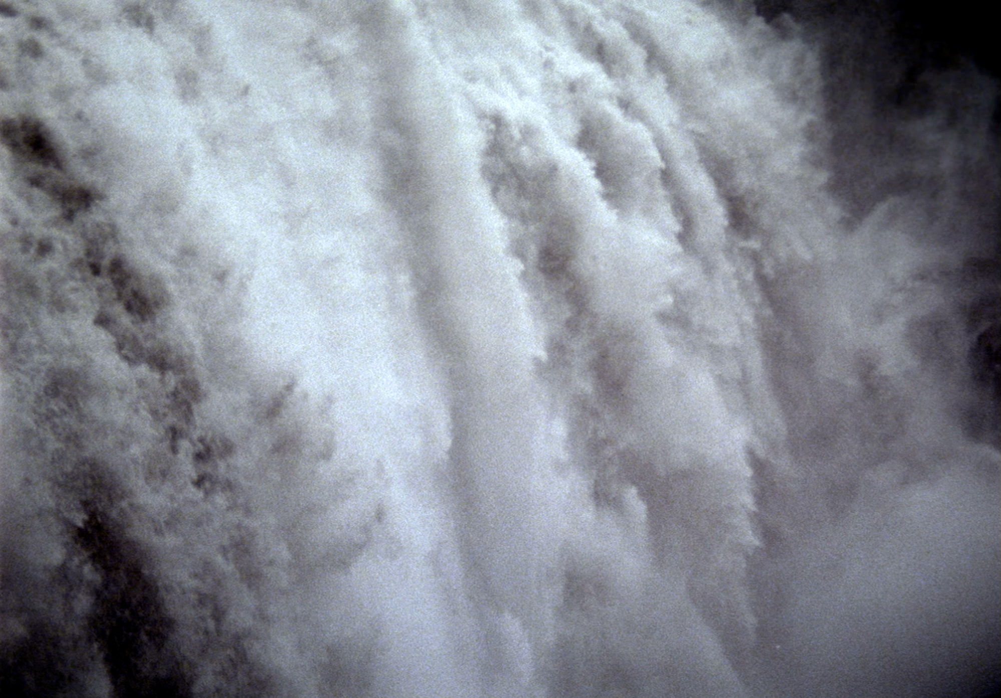 At Any Given Moment, Fall, 2009. Video art installation consisting of video projection, 4 tons of lava rocks and gravel, and sound. Sound by Drew Schnurr. The waterfall is ‘Detiffoss,’ the largest waterfall in Europe, located in the north of Iceland. It was shot in 2006 with my 16mm Bolex at 60 fps and transferred to high definition video. (still frame)