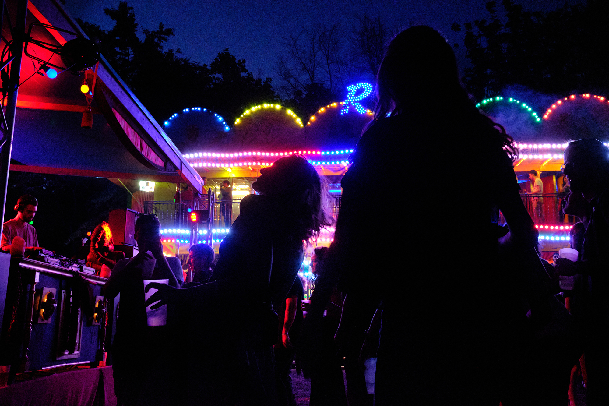 Philippe Sarfati-festival-photography-photographer-street-documentary-madame-loyal-paris-france-women-dancing-silhouette-dj-bright-lights-yellow-blue-crowd
