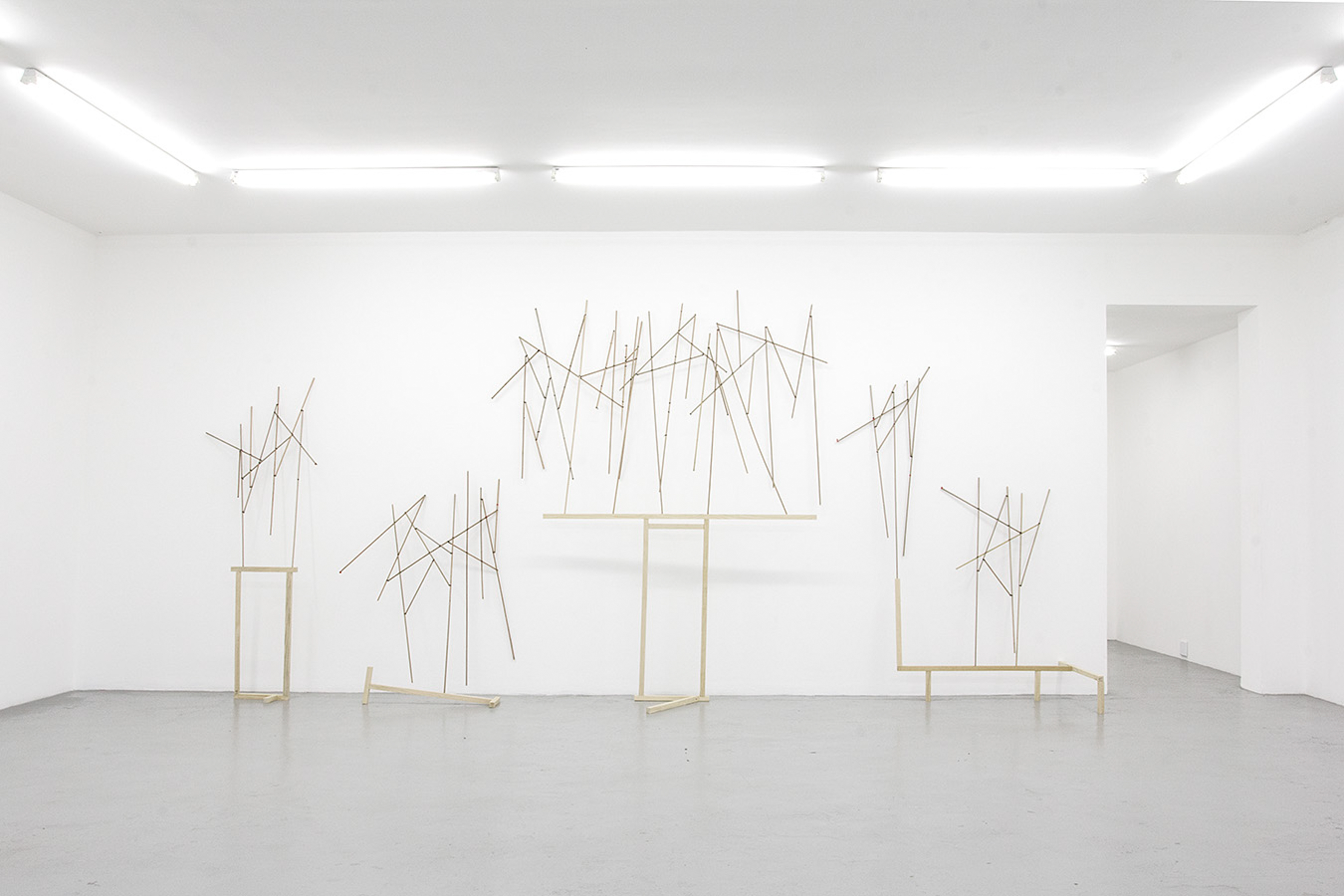 Jonah Sack,  Frieze  (2016) | Dowel sticks, wood and silicone tape ; approx. 277 x 605 x 79 cm