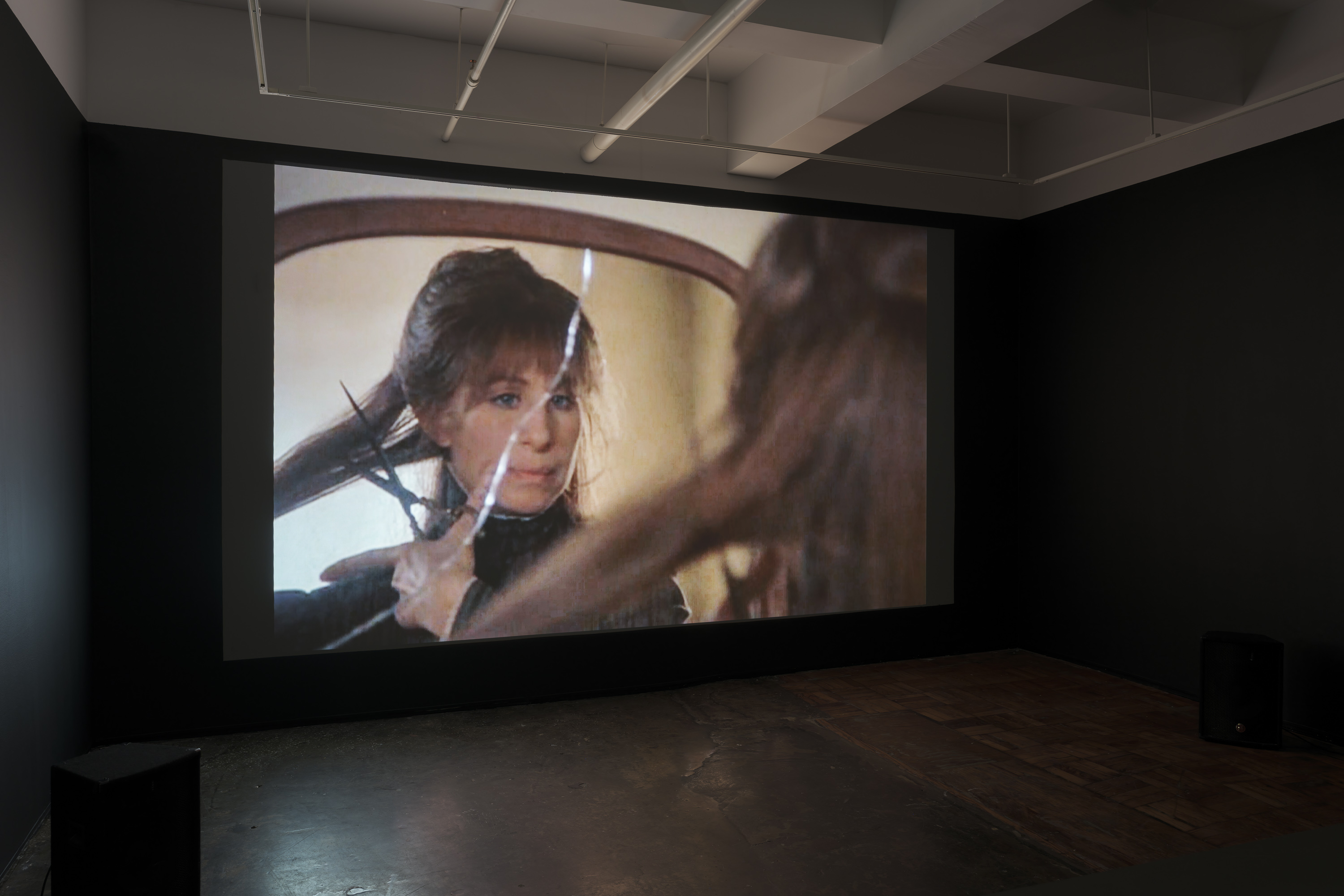 3/11 — THE HAIRCUTThe Haircut reconstructs selected scenes from movies where female characters cut their hair or have their haircut unwillingly. Reasons range from pretending to be a man to compete in a horse race (National Velvet, 1944), embodying a feline aesthetic as a vigilant antiheroine (Catwoman, 2004), aligning with male military standards (GI Jane, 1997), to retaliation by classmates for being involved in a severe cyber-bullying case (We Not Naughty, 2012).The provided file hosts a ten-minute excerpt from the project. The full-scale work contains close to 600 scenes with an approximate duration of 18 hours, to be presented as a single-channel video installation.Video, 18 hours, 2018-2020. Installation images at AIR gallery by Sebastian Bach