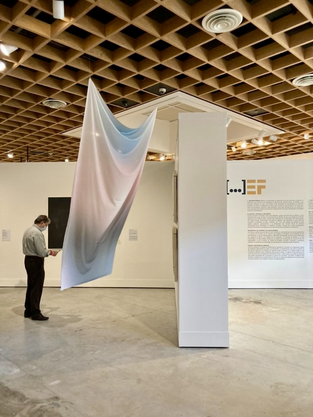 Zilia (Aura Series) 2020 Printed Silk &  Electric Fan   scented aura portrait and homage. I wanted the wind to replicate the waves found in Zilia Sanchez’s work and also the feeling of sleeping under a soft Caribbean abanico breeze. The oceanic scent is reminiscent of Zilia’s actions between her canvases and the sea, composed of Myrrh, Lavandin, Coconut Isolate, Calone, Cypress, and Holy Basil. It is an open smell, de mar, amplitude, and generosity.