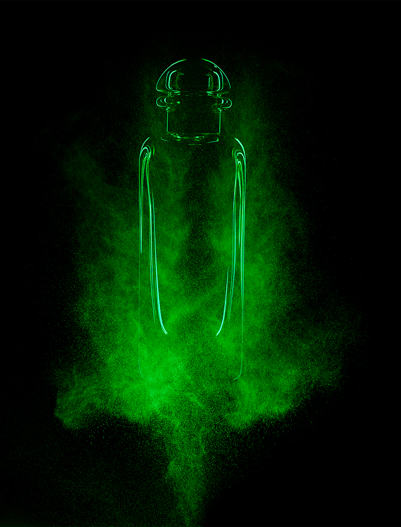 KMA photographer Isabelle Bonjean shoots a close up photograph of a perfume bottle with green smoke for Faux Q Magazine