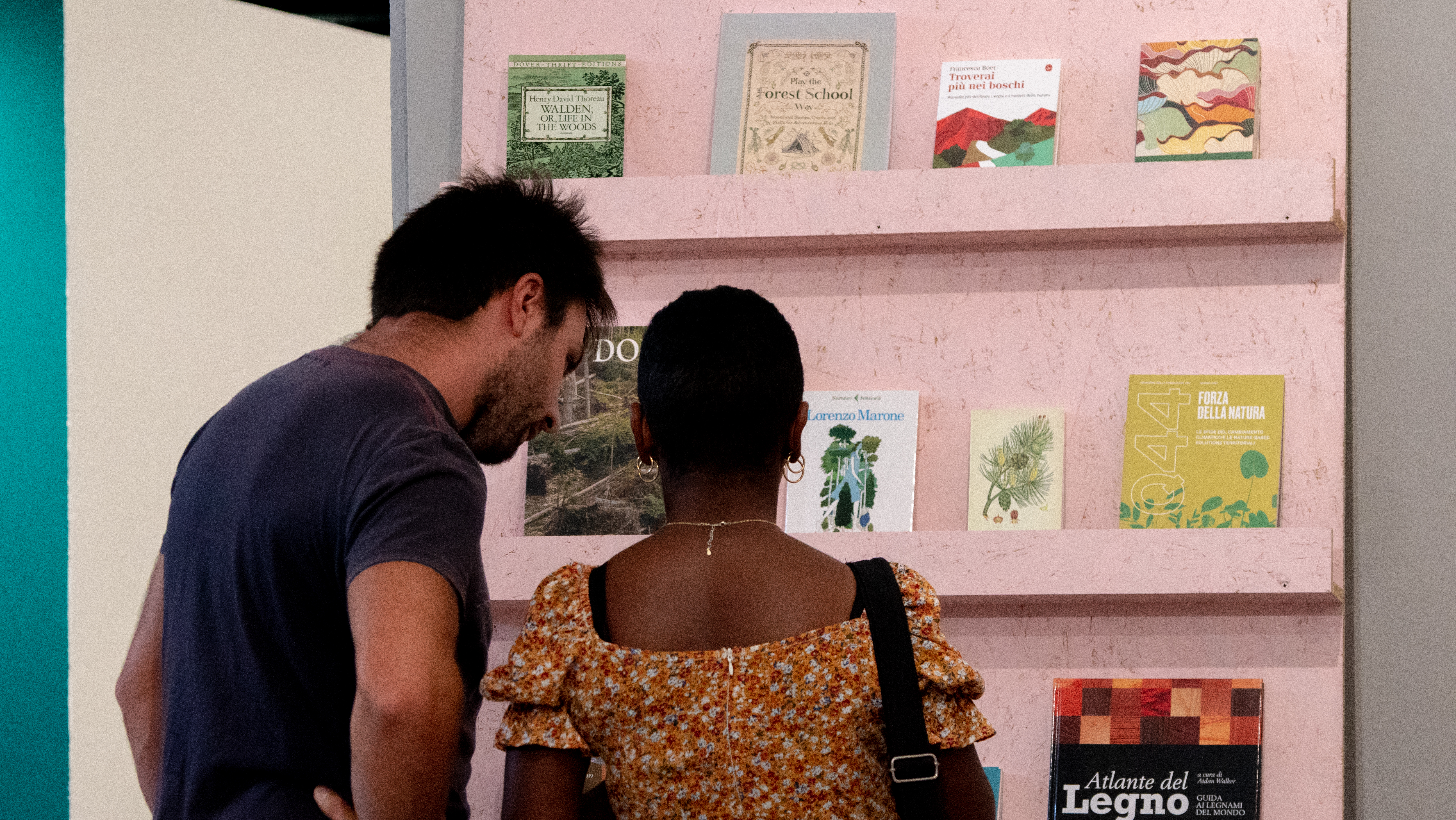 Visitor engaging with the bookshelf