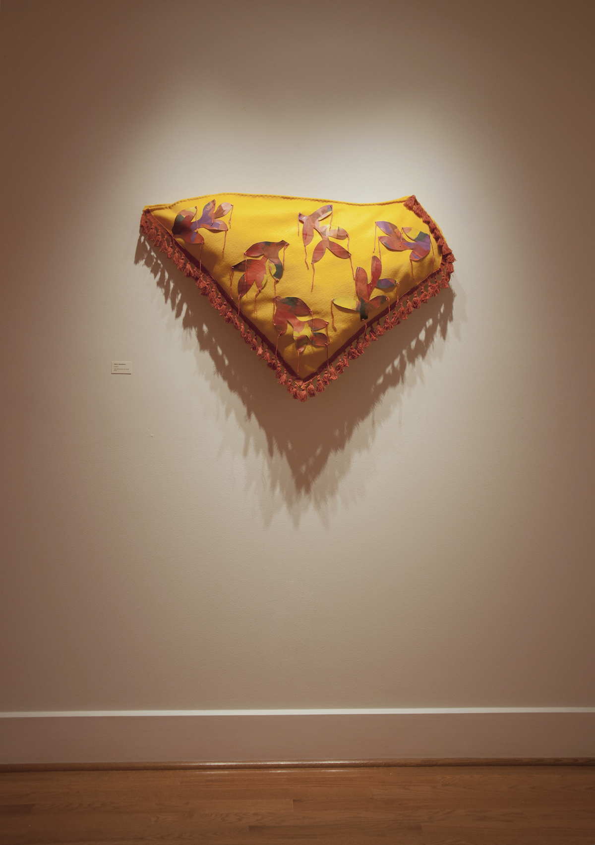 Cushion, 2019, 27" x 43" x 6", felt, painted canvas, trim, fiberfill